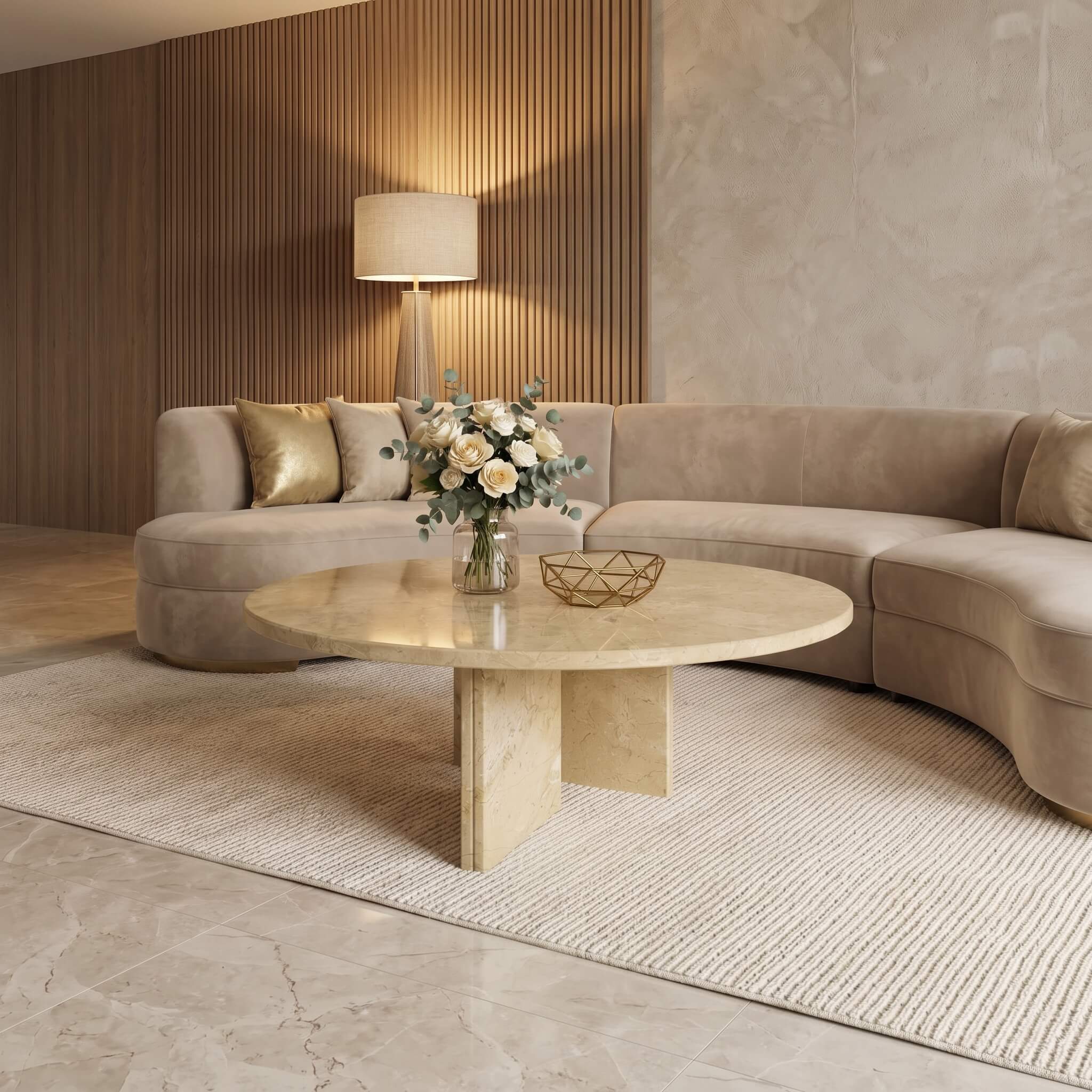 Amber Gold natural marble round coffee table with 70cm top placed on woven rug near beige curved sectional sofa.