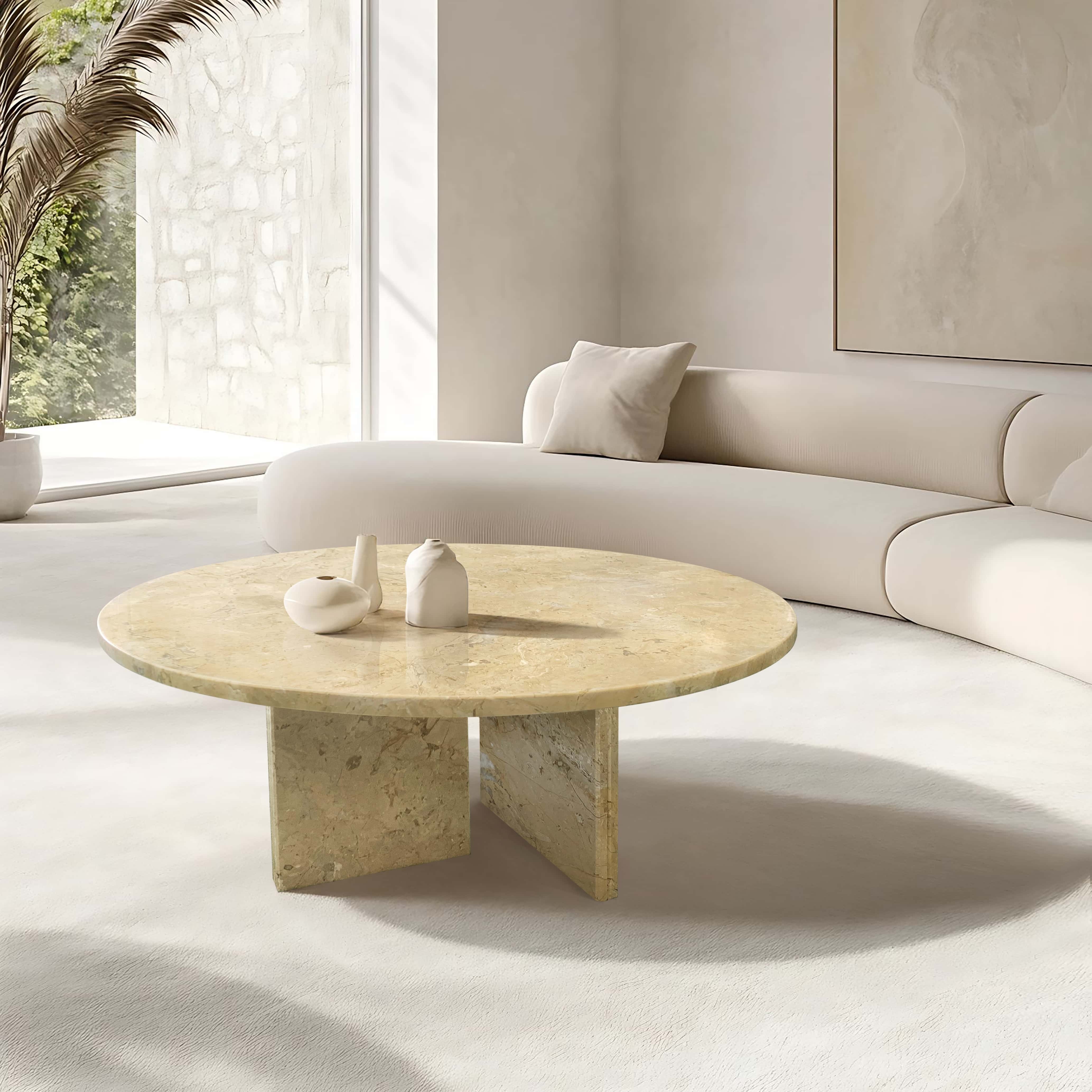Bright serene lounge displaying Amber Gold natural marble round coffee table paired with smooth off-white sectional.