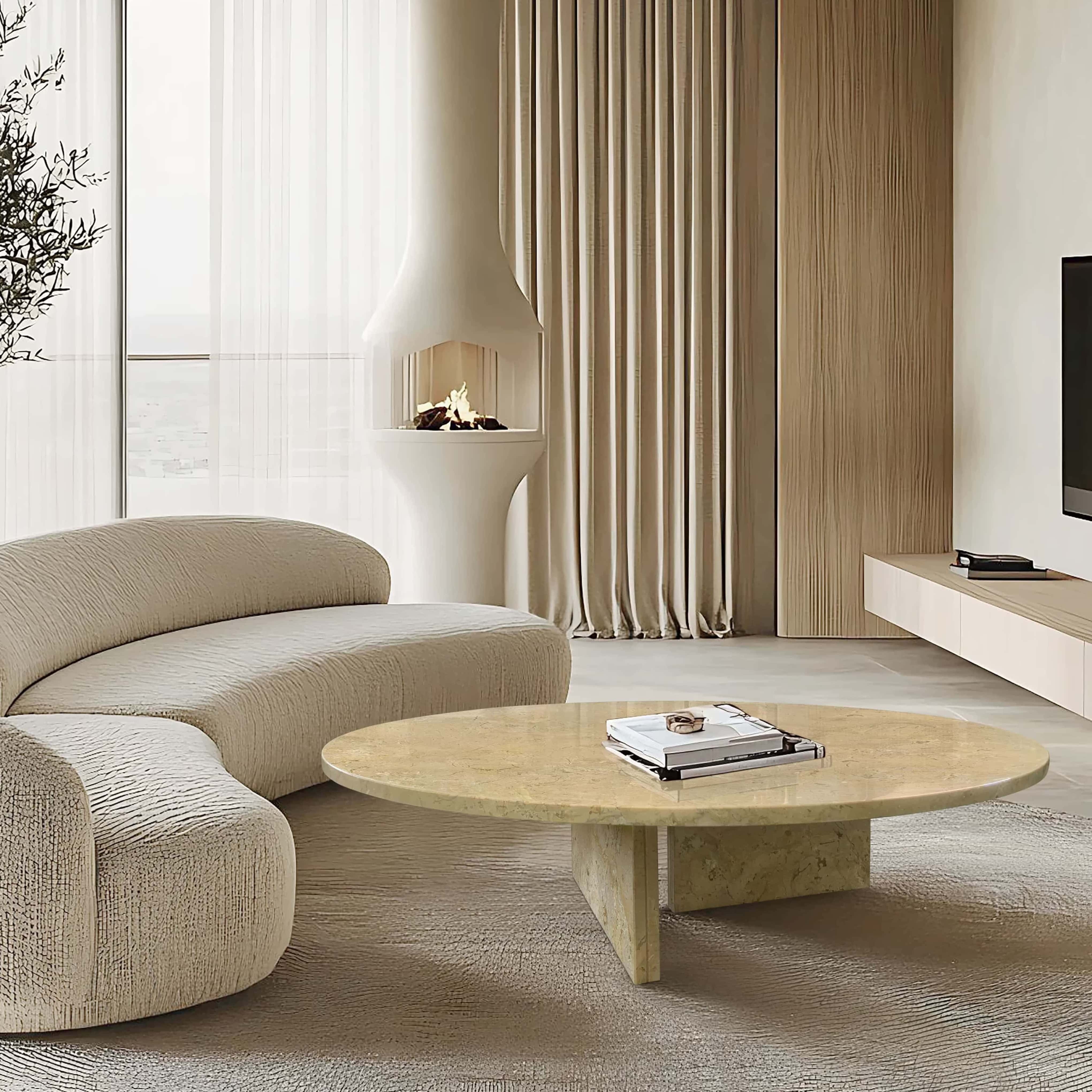 Round Amber Gold marble coffee table paired with curved bouclé sofa beside a modern fireplace in a Japandi-style living room.