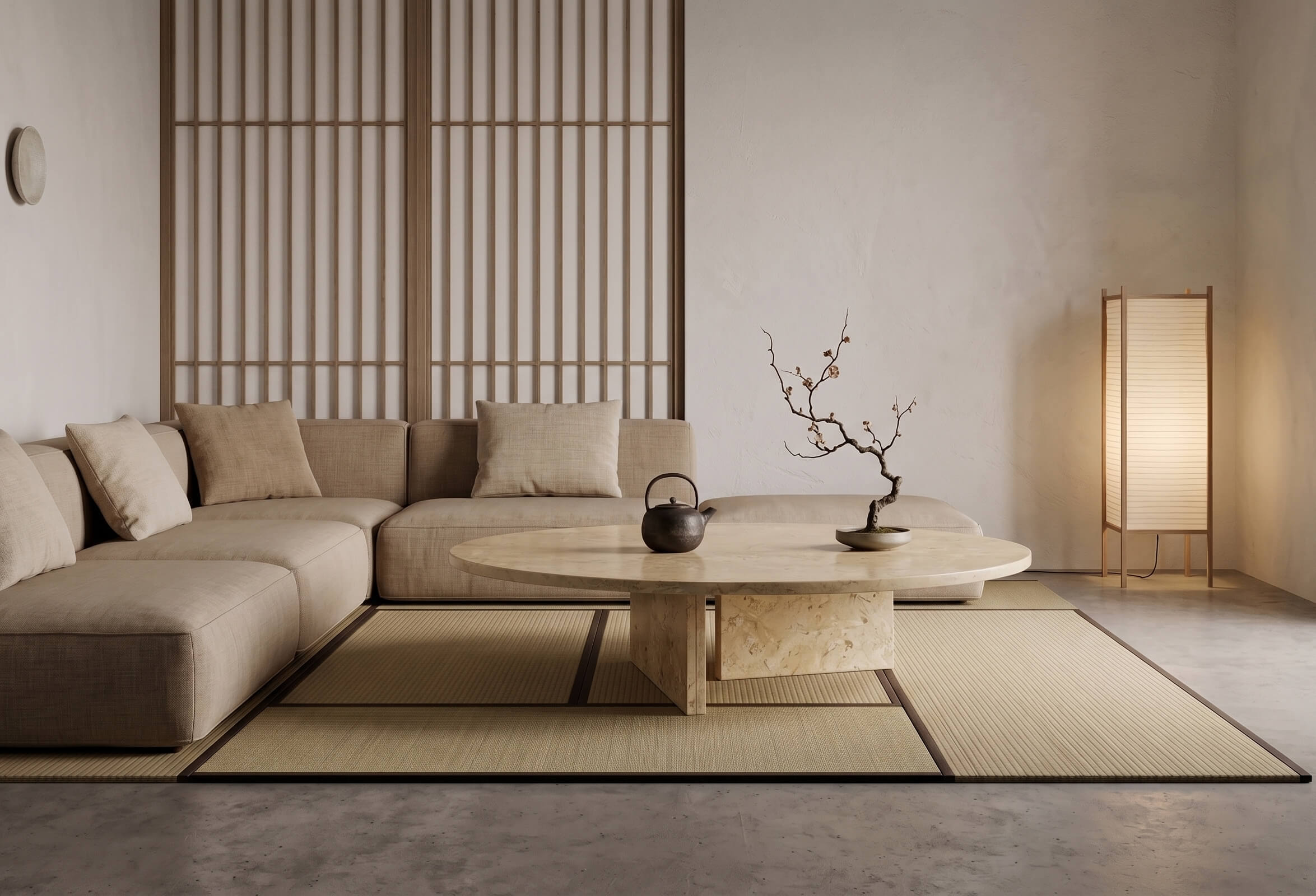 Round Amber Gold marble coffee table styled with iron teapot and plum branch on tatami mats in a Japandi zen sitting room.