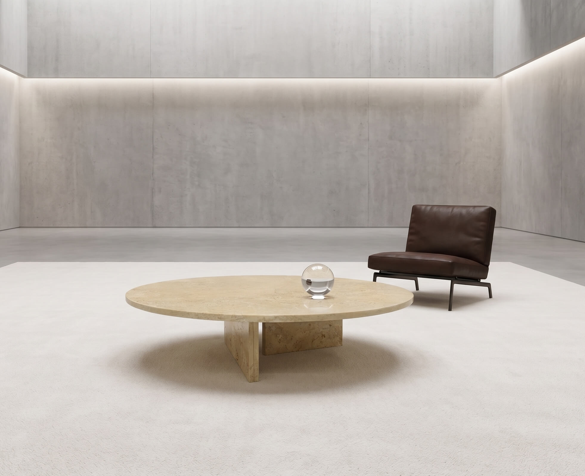 Round Amber Gold marble coffee table paired with a brown leather lounge chair in a minimalist concrete loft interior.