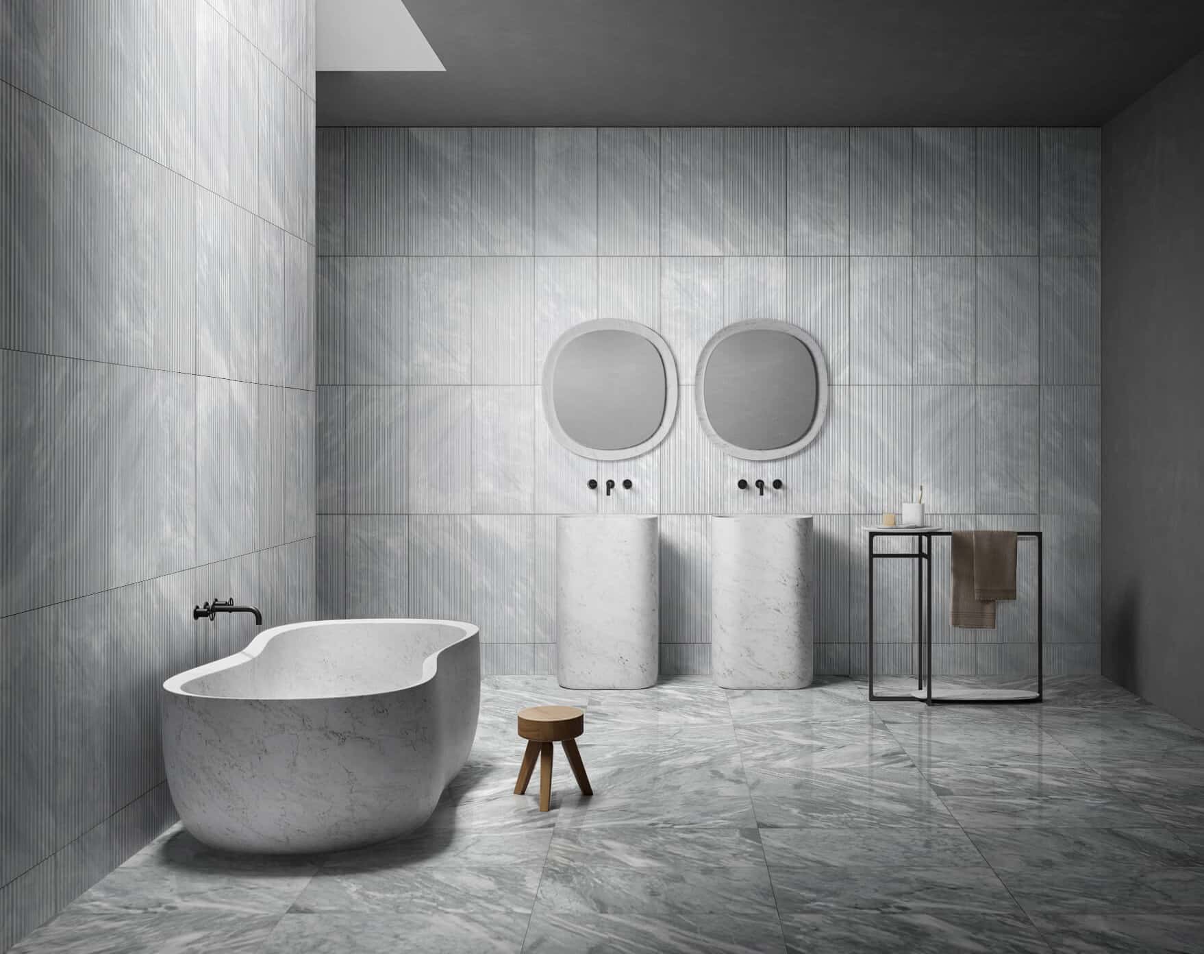 Luxury bathroom with double pedestal sinks, freestanding tub, 12x24 Carrara Gray polished floor and textured wall tiles.