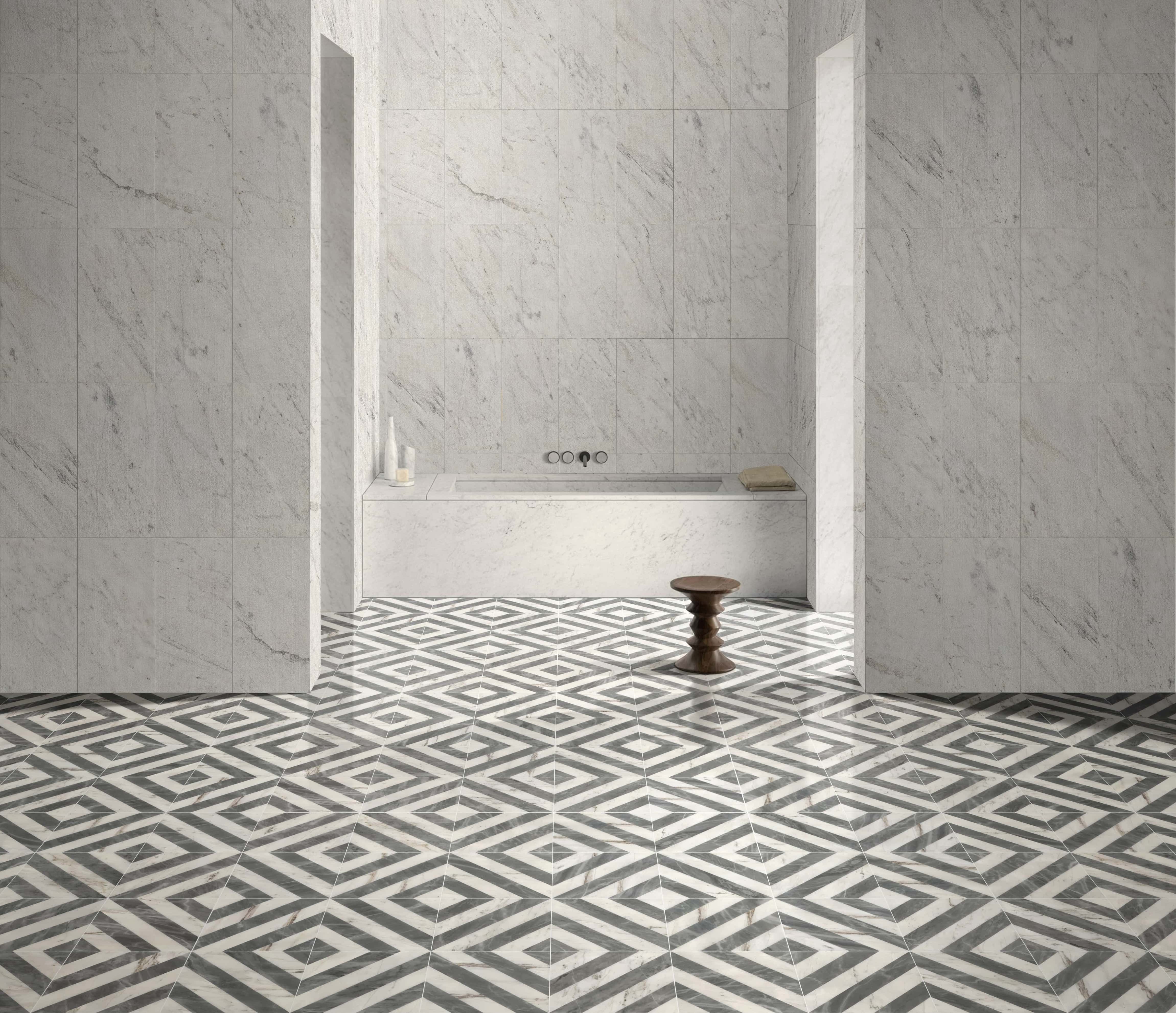 Minimalist bathroom floor in waterjet marble paired with 12x24 Snow Mountain White FS textured marble wall tile.
