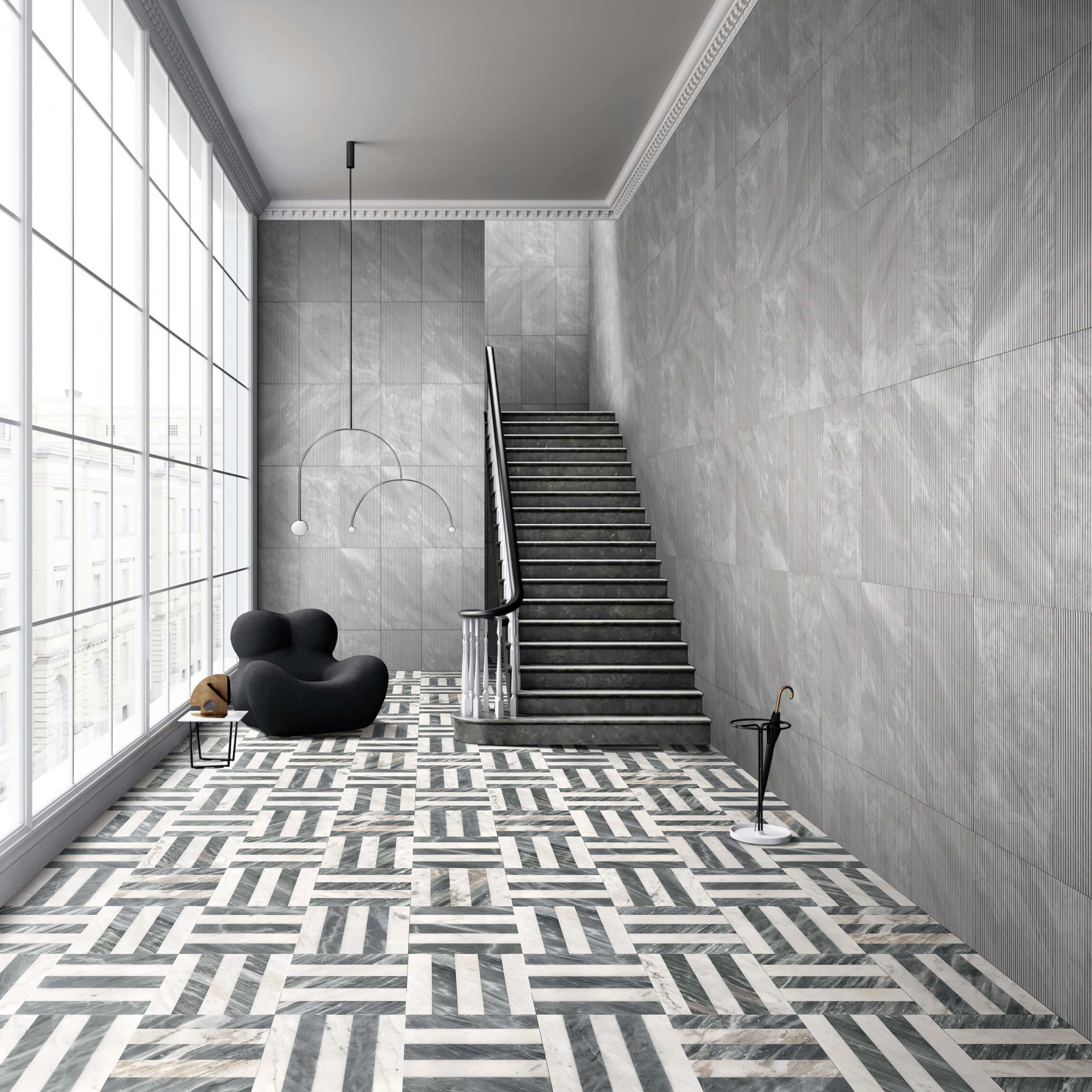 High-ceiling hallway with Carrara Gray fluted textured marble wall tiles and woven waterjet marble tile flooring.