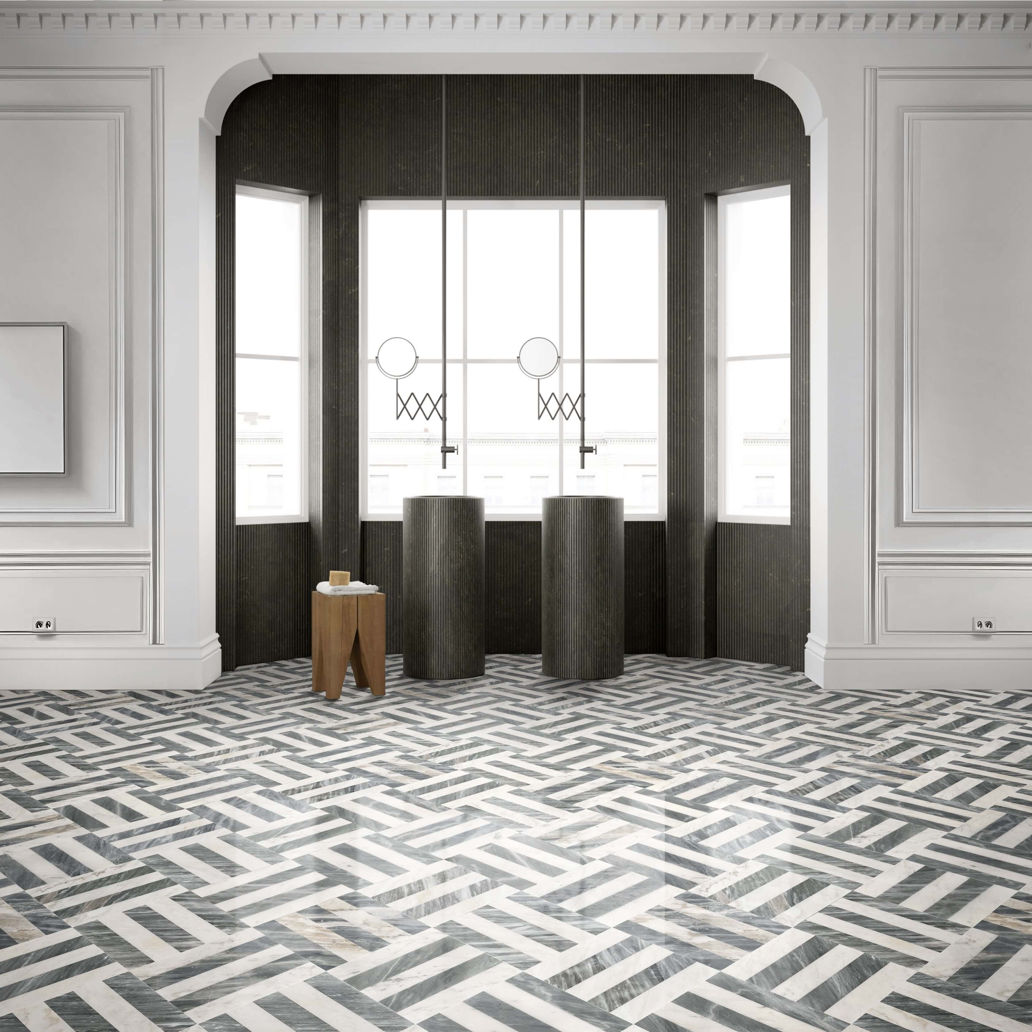 Architectural luxury bathroom with dual pedestal sinks and Snow Mountain White Carrara Gray woven marble floor tiles.