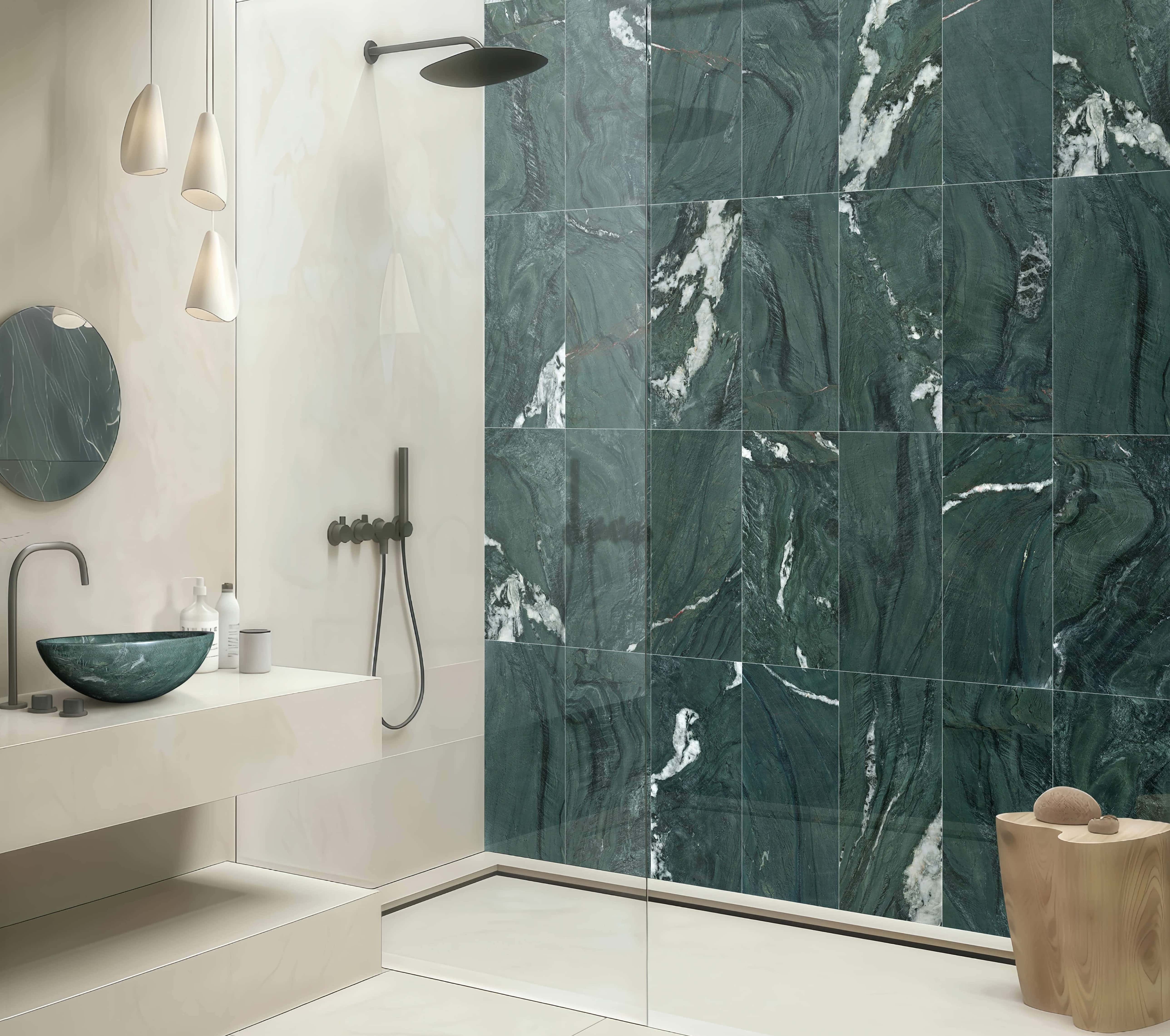 Custom bathroom design matching a diamond green polished marble vessel sink with continuous 12x24 marble shower tiles.