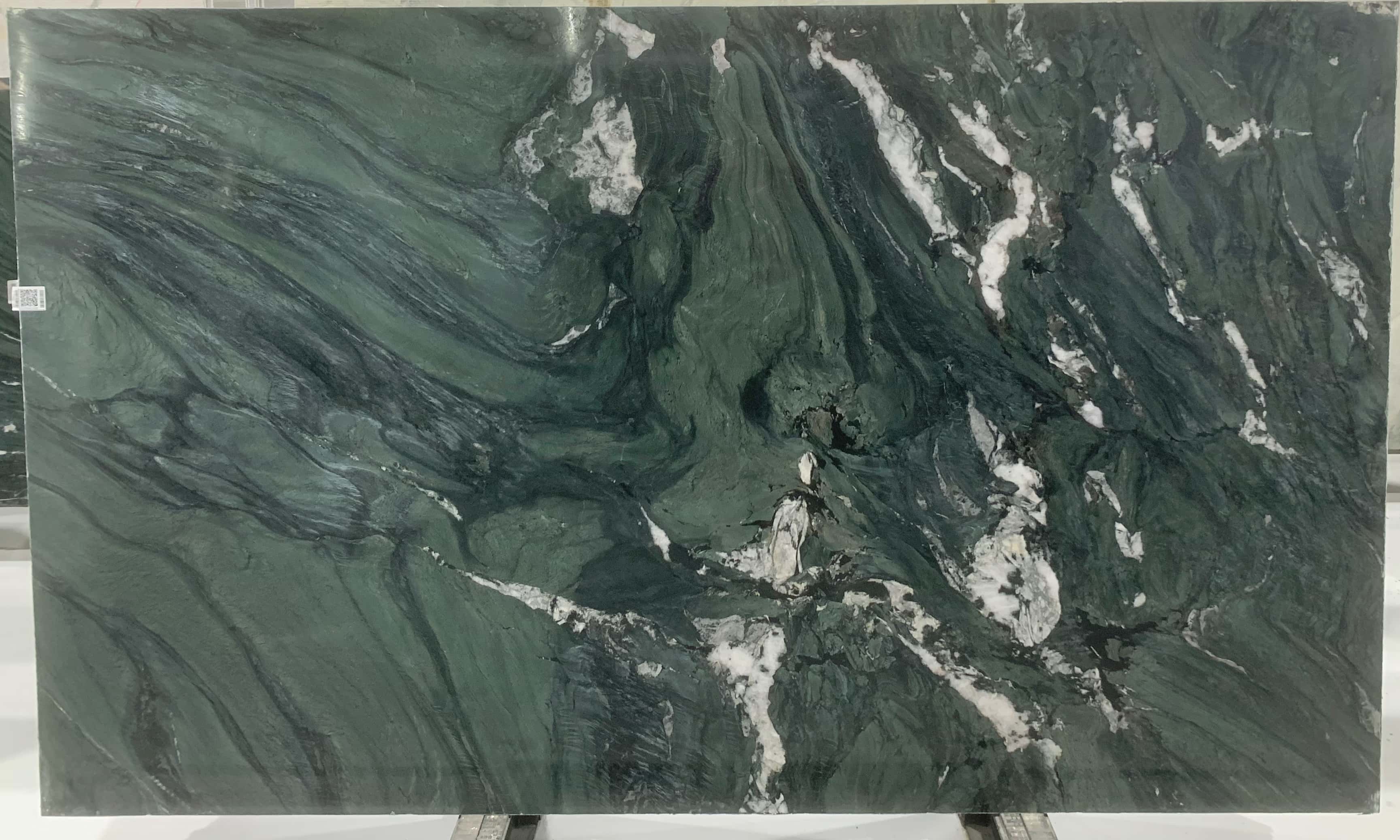 Full polished slab of diamond green natural marble, displaying the dramatic white quartz veining before being cut to size.