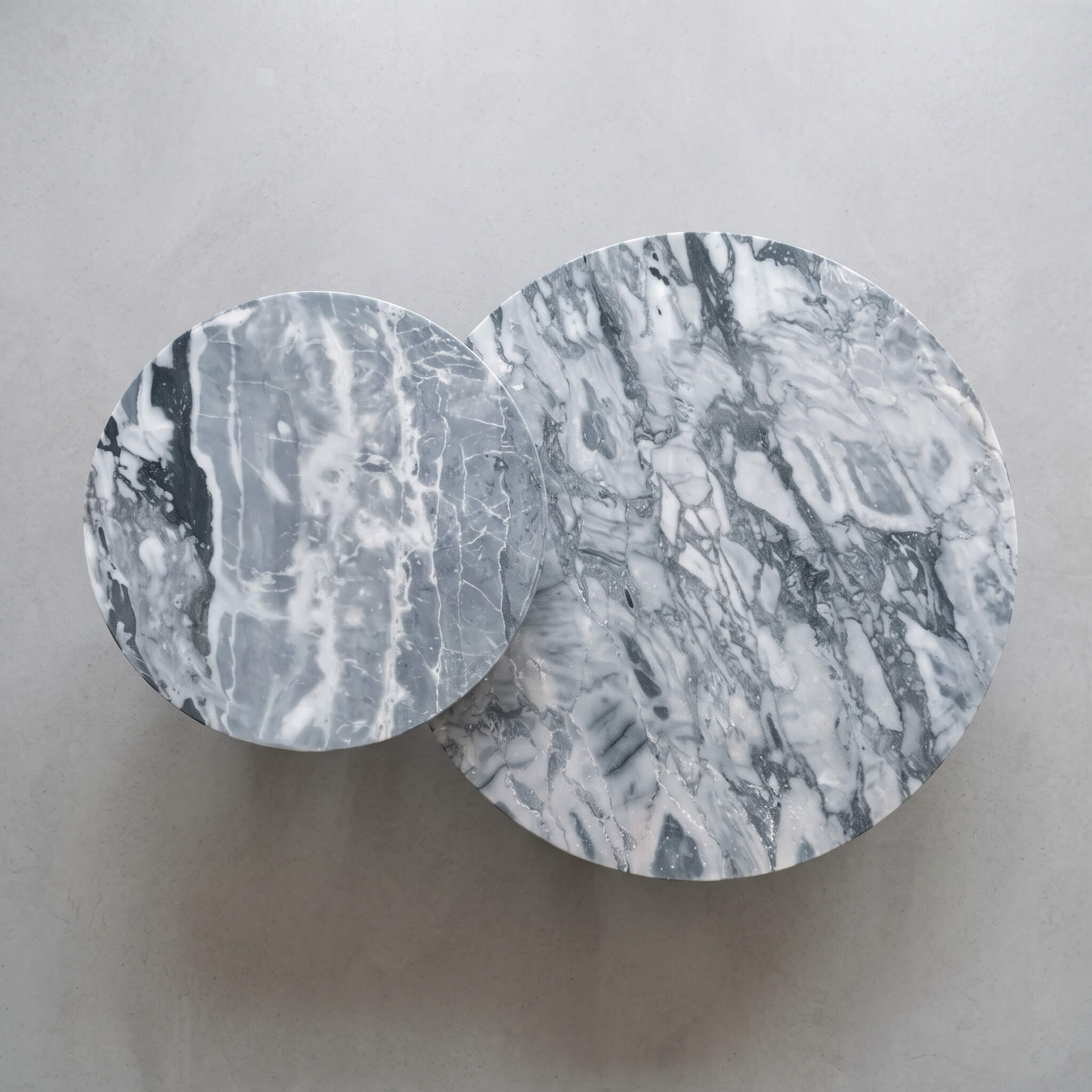 Topdown view of a round blue marble table set highlighting the unique natural cloudy blue veining on solid polished stone.