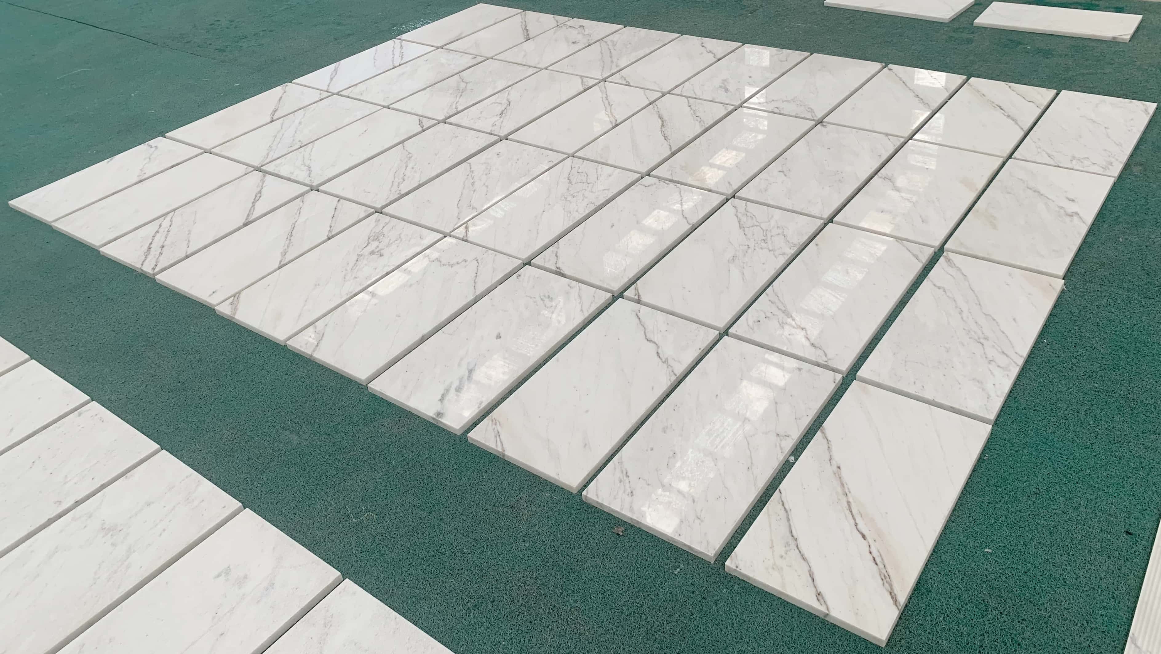 Batch of Snow Mountain white marble tiles with unique gray veining, perfect for elegant stone tiles for walls or floors.