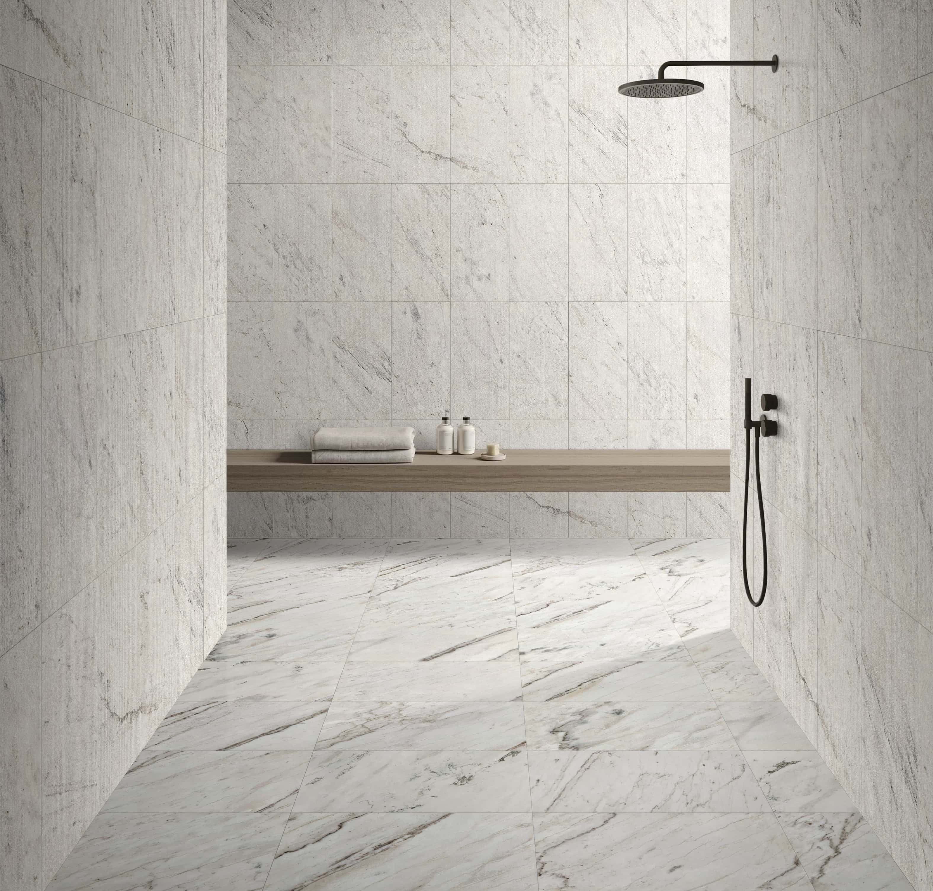 Modern bathroom combining Snow Mountain White FS textured marble wall tiles with polished marble tiles on the floor.