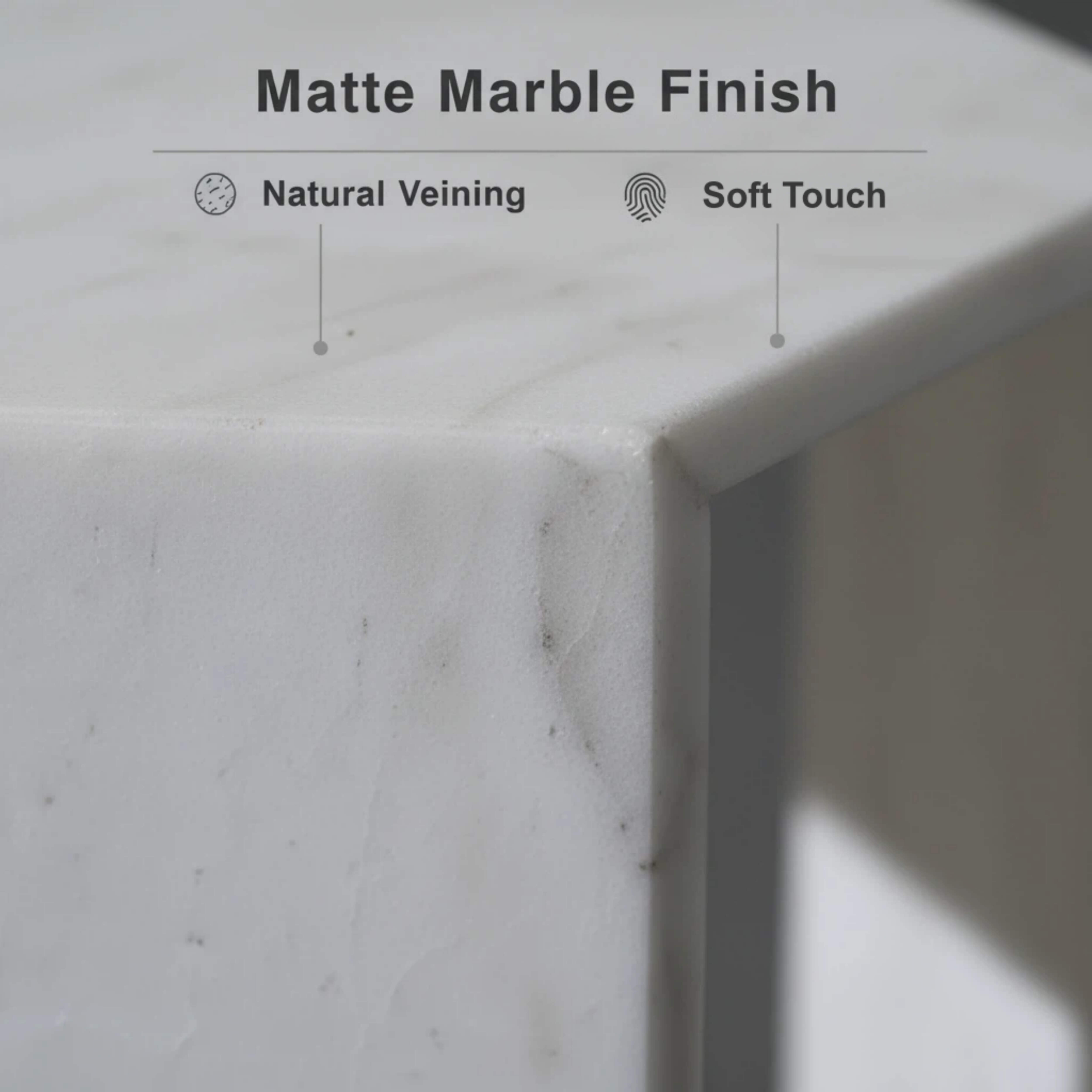 Close-up of the honed matte finish on the Snow Mountain White marble hexagon table, highlighting natural veining and edges.