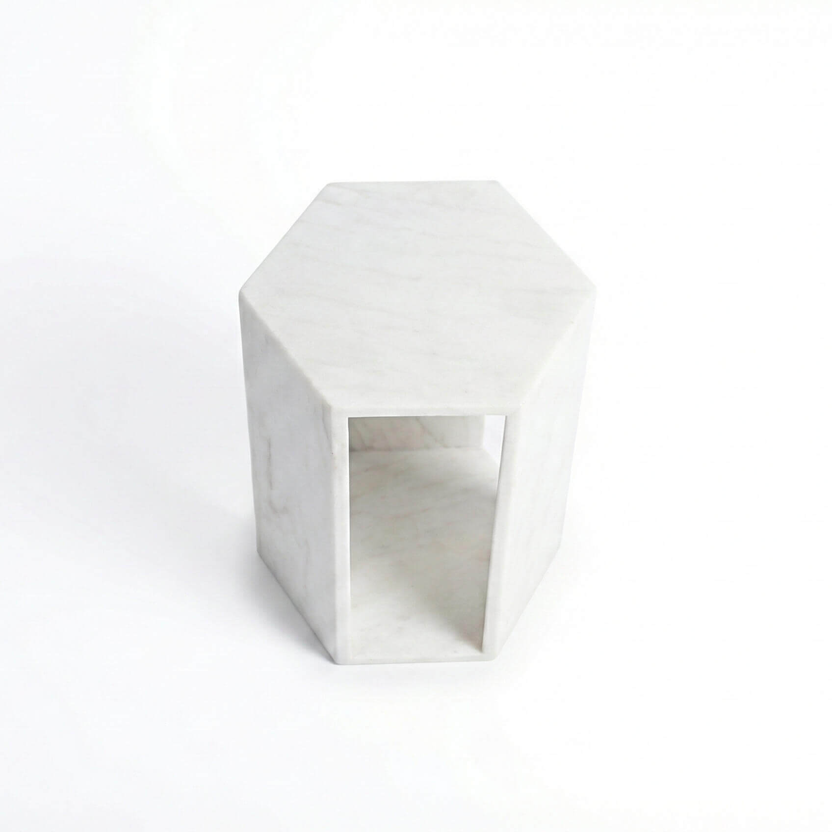 Angled view of the honed Snow Mountain White marble drink table, highlighting its seamless natural stone construction.