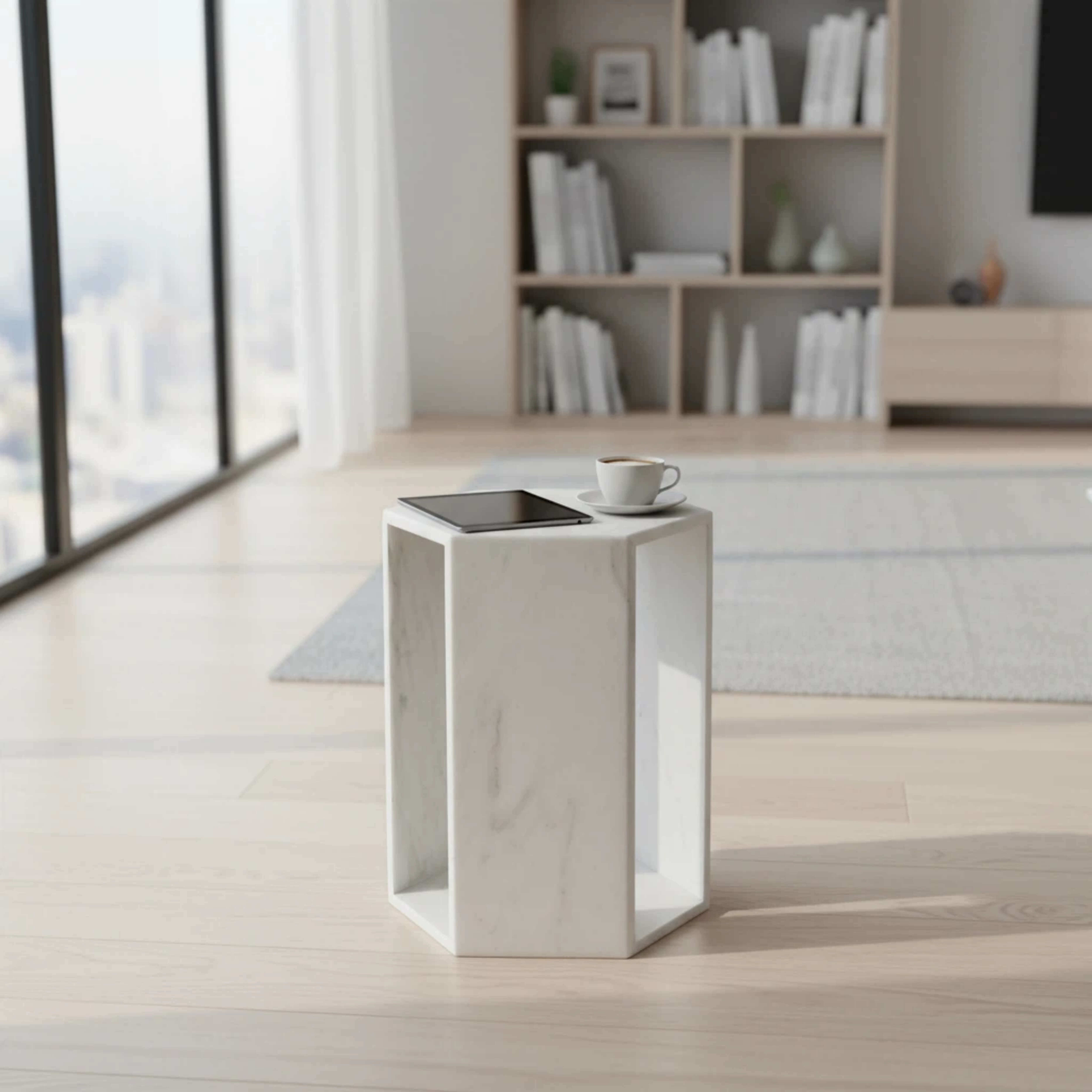 A honed Snow Mountain White marble hexagon end table holding a tablet and coffee in a bright minimalist living room space.