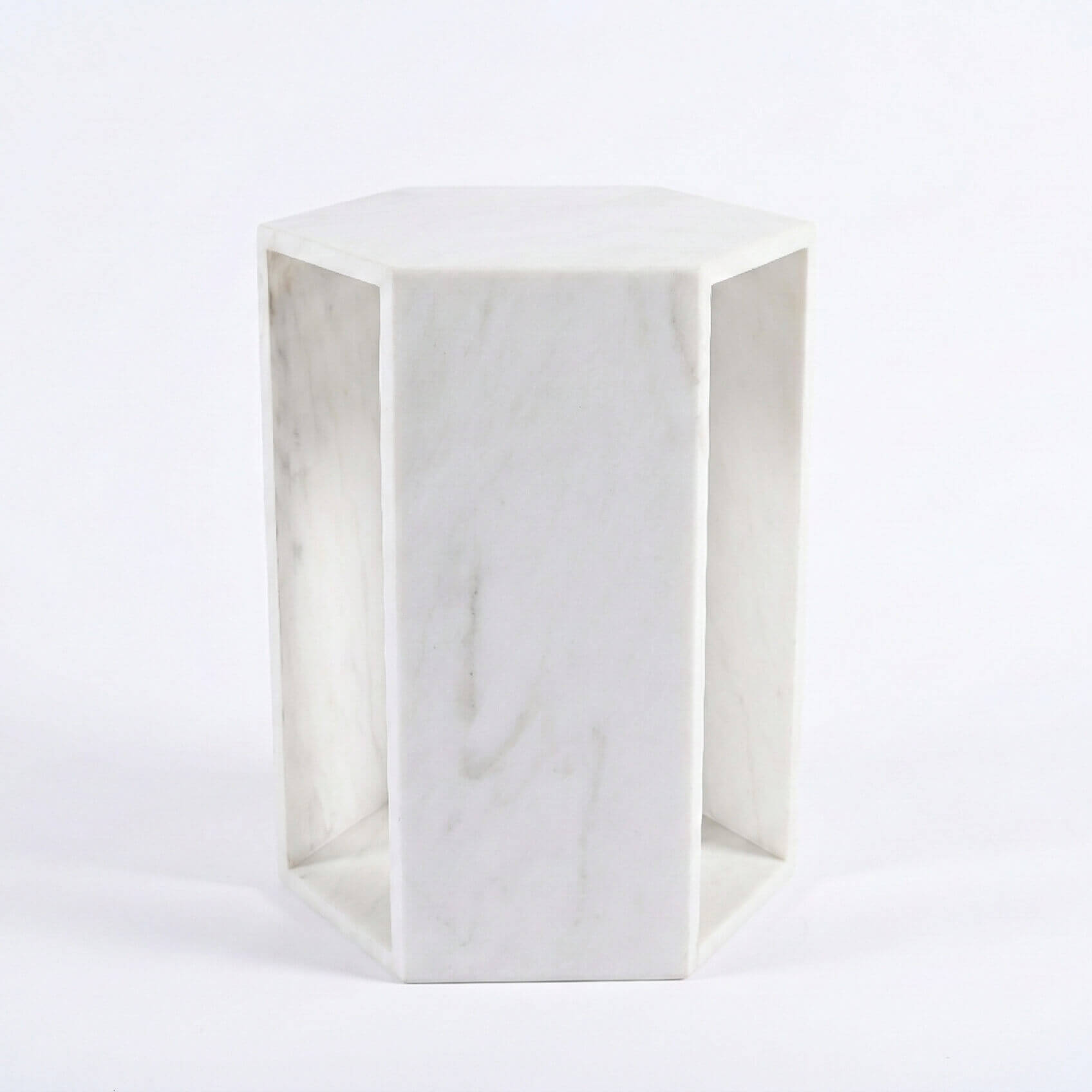 Straight view of the honed Snow Mountain White marble geometric drink table, showcasing pure white tones and hollow core.