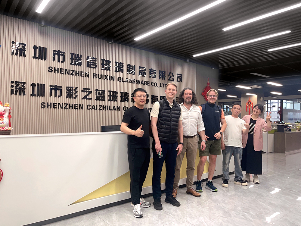 International partners inspecting glassware quality