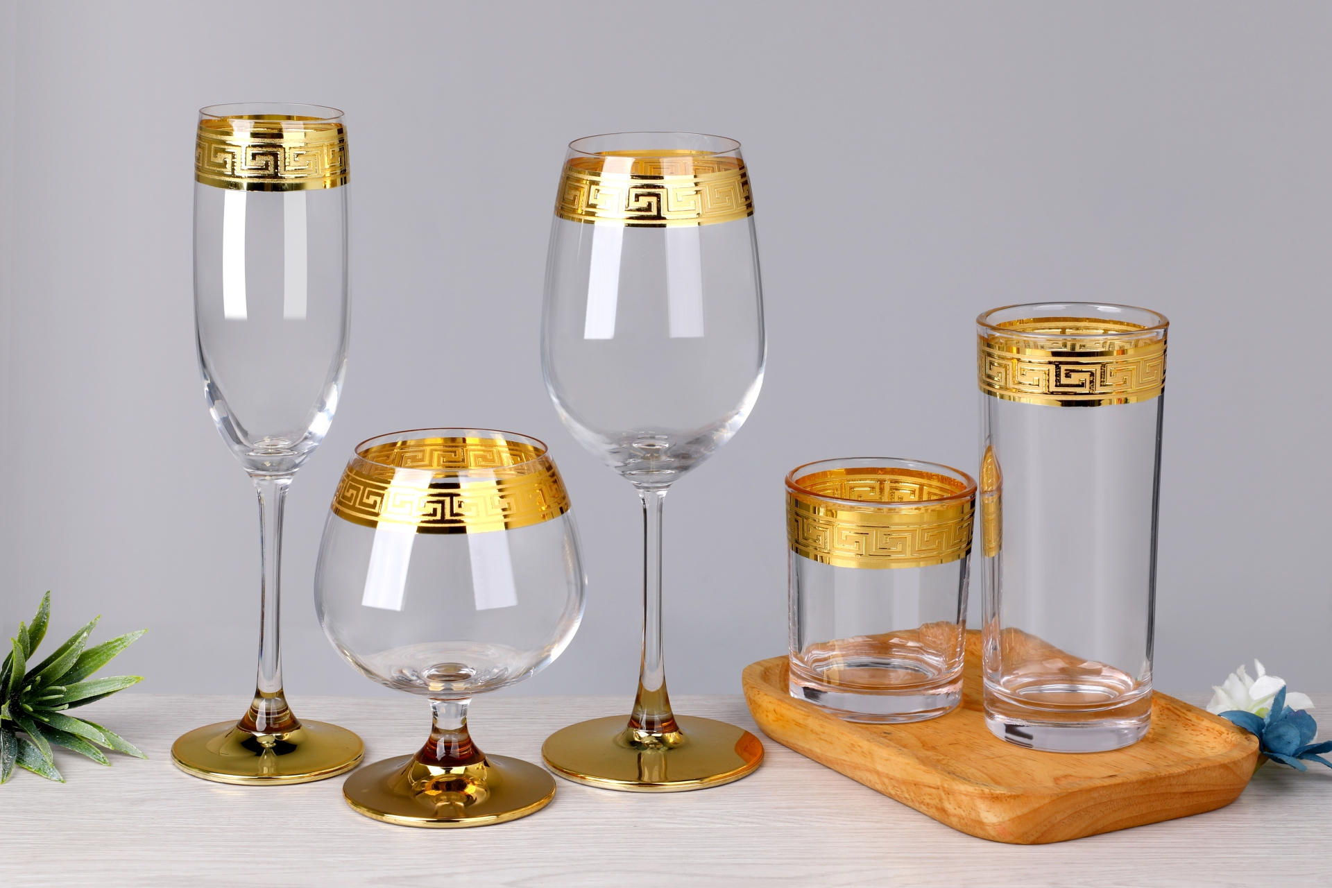 Assorted gold rim wine, champagne and whiskey glasses