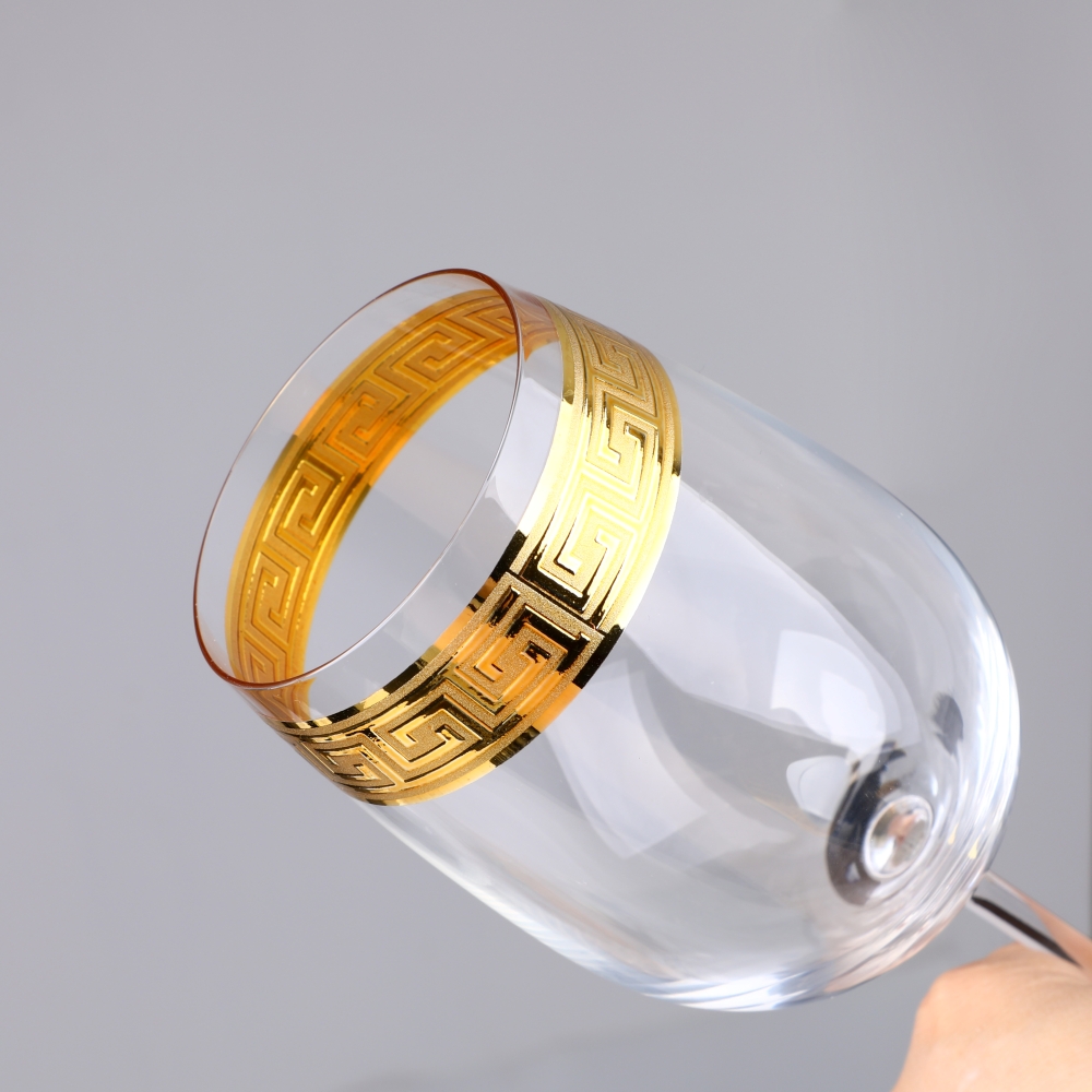 Detail of Greek key gold rim on wine glass