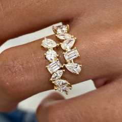 Close-up shot of a woman's hand wearing a luxurious 14k gold mixed cut lab diamond ring, showcasing the sparkle of VS clarity stones against the skin.