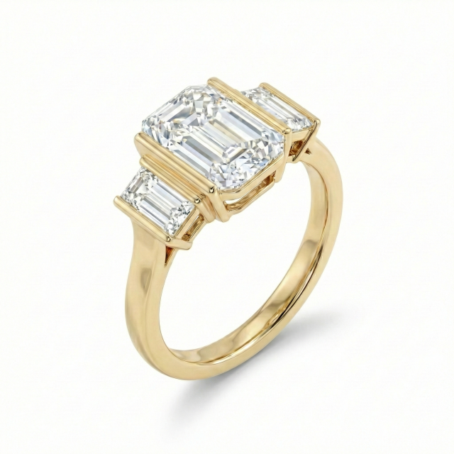 Detailed angled shot focusing on the polished 14k yellow gold shank and the seamless transition to the baguette side stones of this lab grown diamond ring.