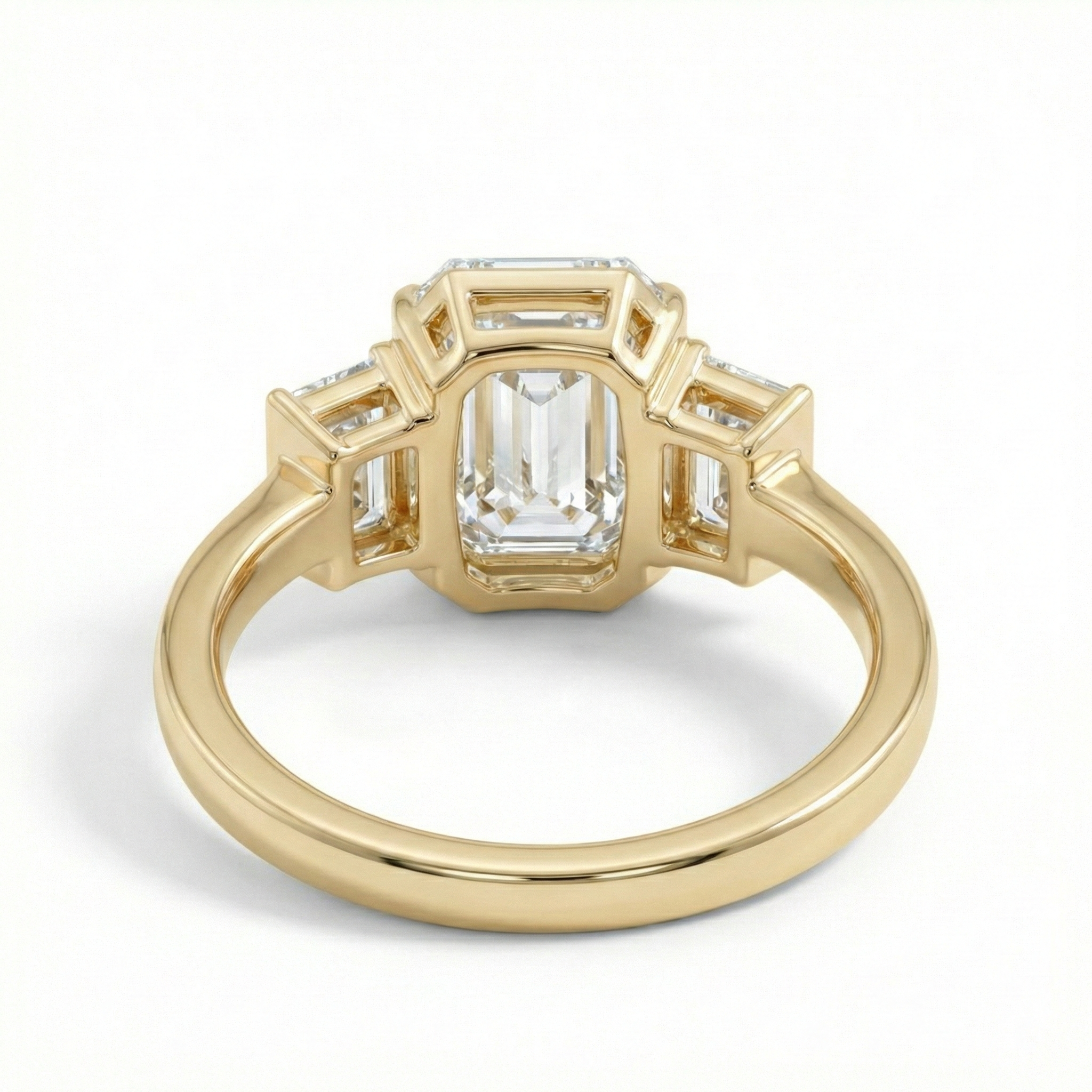 Underside view of the ring showing the open gallery setting which allows maximum light to enter the 1.5ct emerald cut diamond for enhanced brilliance.