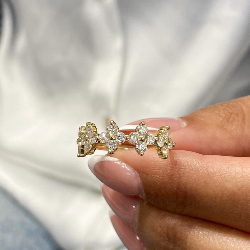 Macro detail of the prong setting on a lab-grown diamond floral ring, showing the open gallery that allows maximum light reflection.