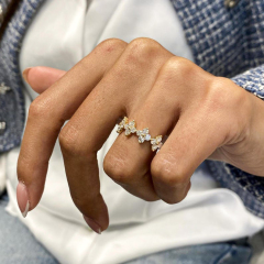 Styled shot of a women's nature-inspired diamond ring on hand, demonstrating its delicate floral look suitable for stacking or everyday wear.
