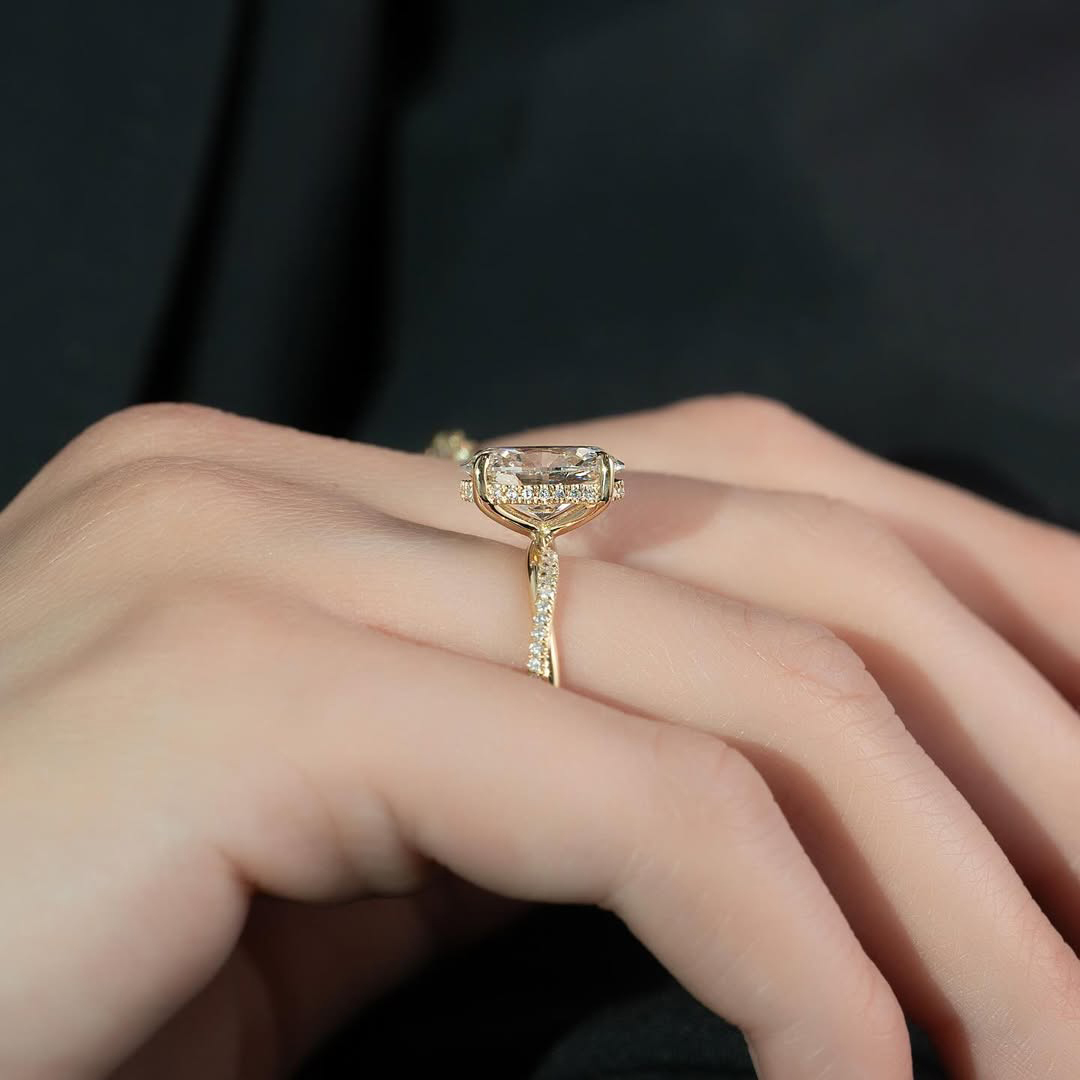 Side profile view of Oval Engagement Ring on finger showing basket height and hidden halo