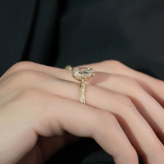 Side profile view of Oval Engagement Ring on finger showing basket height and hidden halo