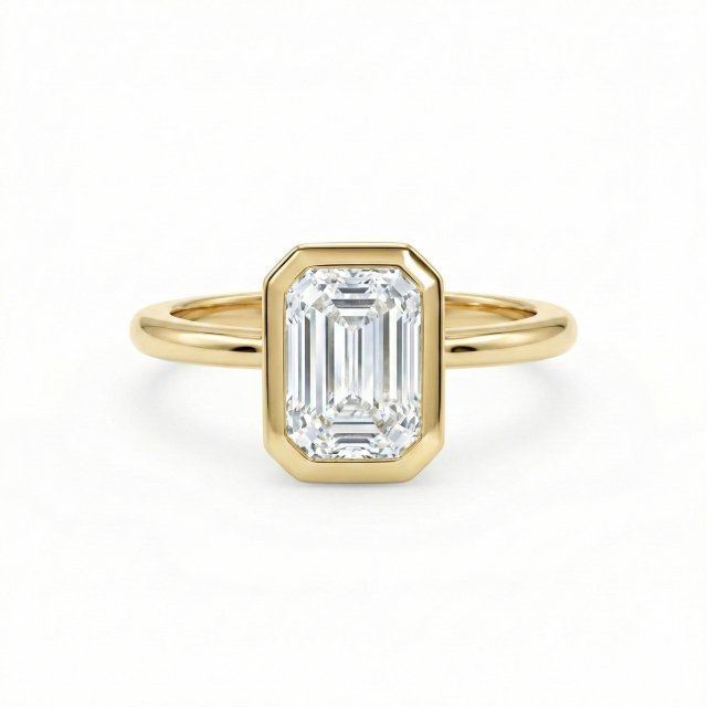 E color VVS2 clarity 1.5ct emerald cut lab diamond in a snag-free 14K gold bezel setting.