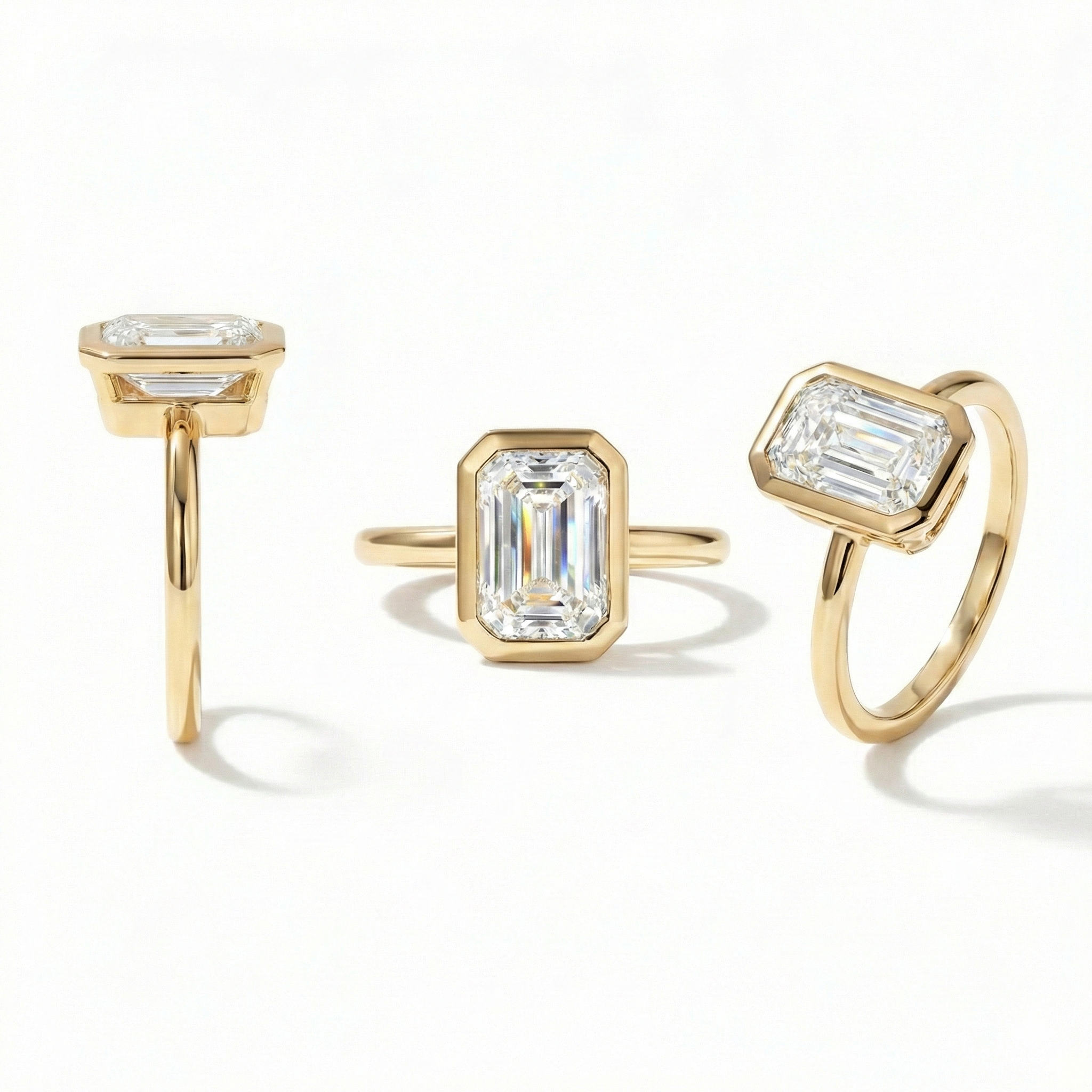 Multiple angles of a modern 1.5 carat emerald cut lab grown diamond bezel engagement ring.