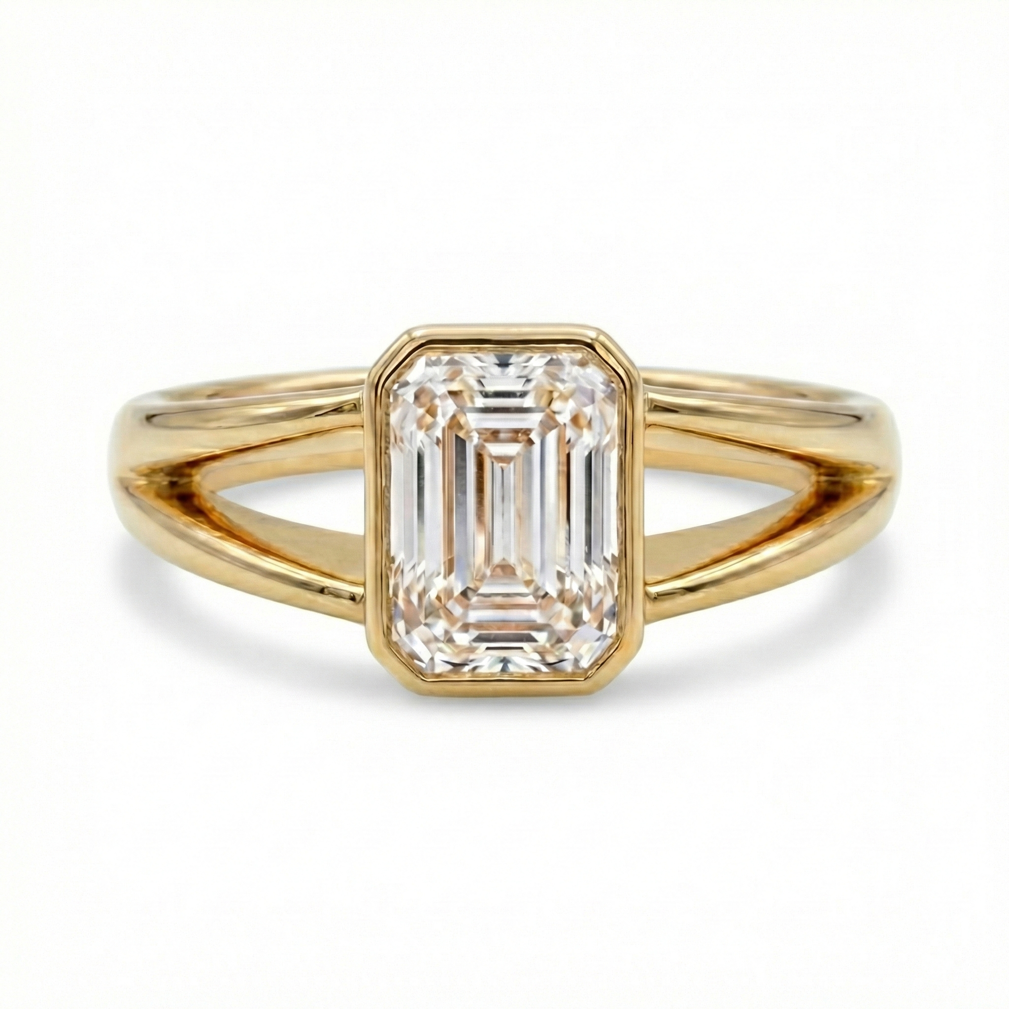 Front profile of a clear E color VVS2 emerald cut lab grown diamond in a modern minimalist bezel setting.