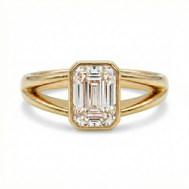 Front profile of a clear E color VVS2 emerald cut lab grown diamond in a modern minimalist bezel setting.