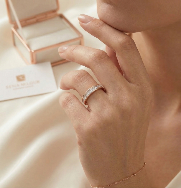 Sophisticated lifestyle shot of a woman wearing the 18K gold princess diamond band, with a luxury jewelry presentation box in the soft-focus background.