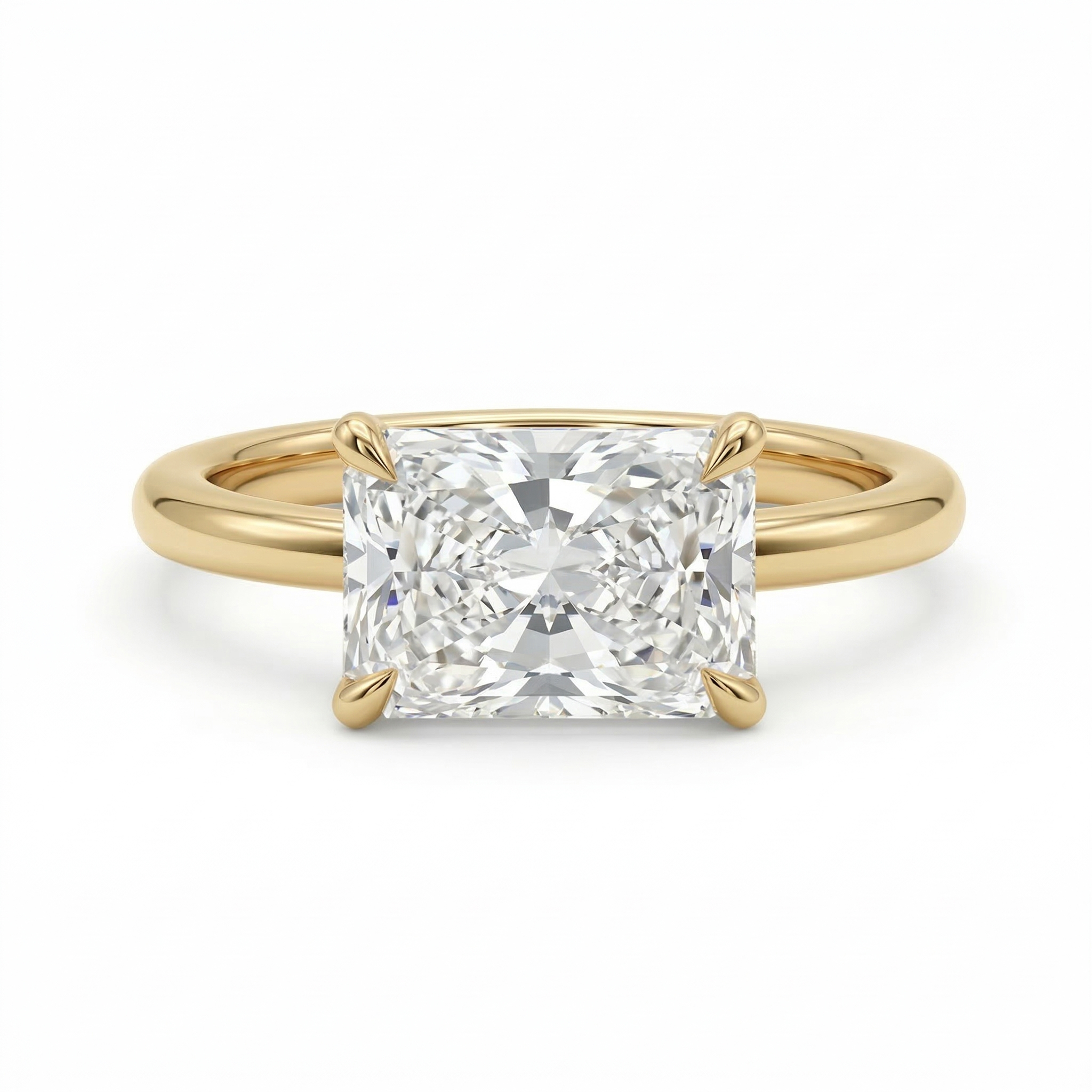 Studio isolation on a pure white background of a flawless-appearing D color, VVS2 clarity radiant cut lab grown diamond set horizontally in a highly polished 14K yellow gold east-west engagement ring band.