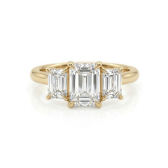 Direct top-down view of an E color VVS2 clarity 2.75 carat emerald cut lab-grown diamond flanked by two emerald cut side stones in 14K gold.