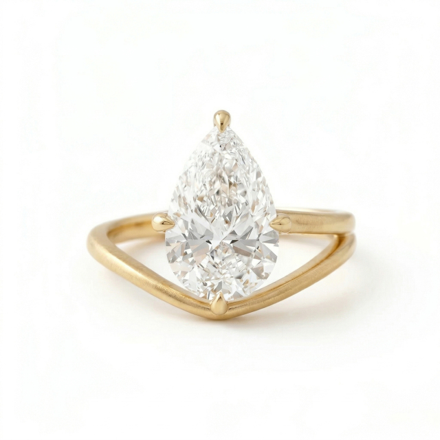 Front view of an excellent cut 3 carat pear shape lab grown diamond ring, illustrating maximum light performance and fire against a modern 14K matte gold setting.