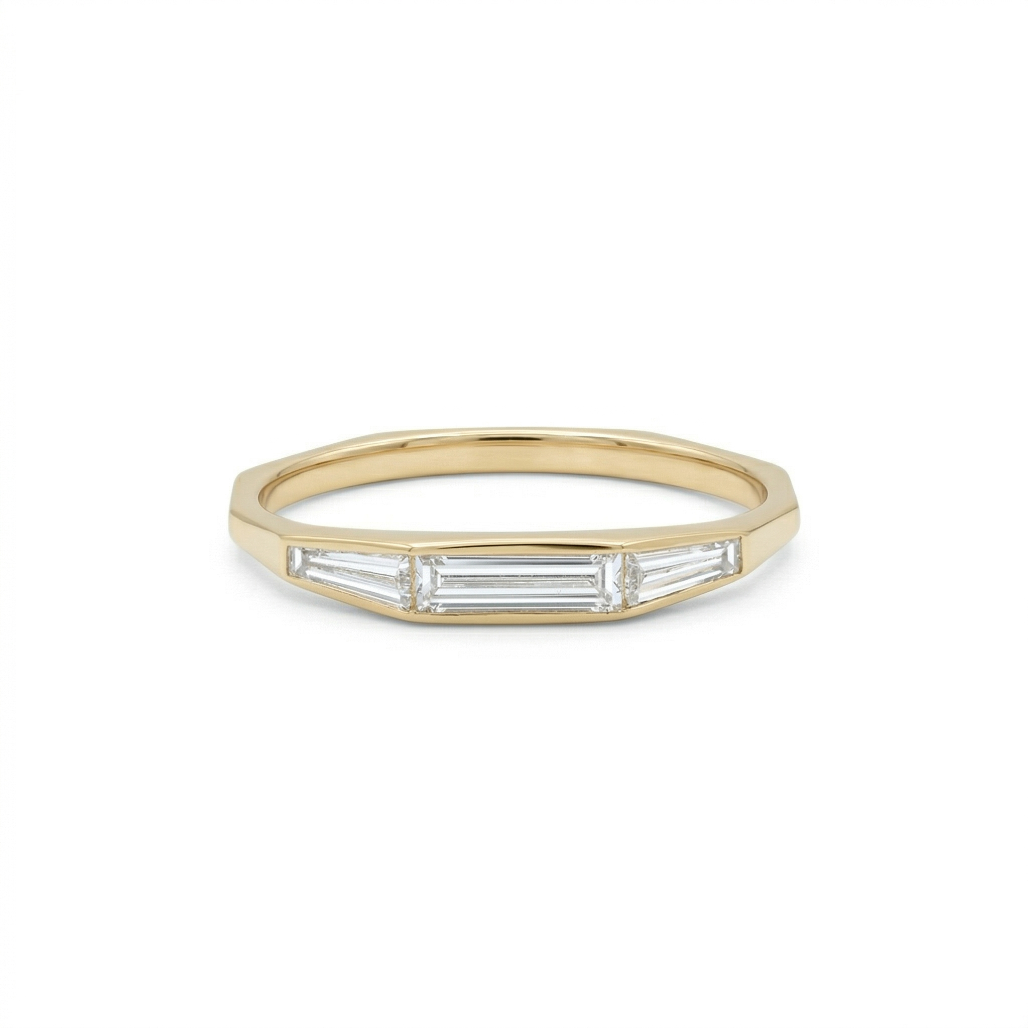 Front view of a 14K gold low profile stackable ring featuring a center straight baguette and side tapered baguette lab diamonds.