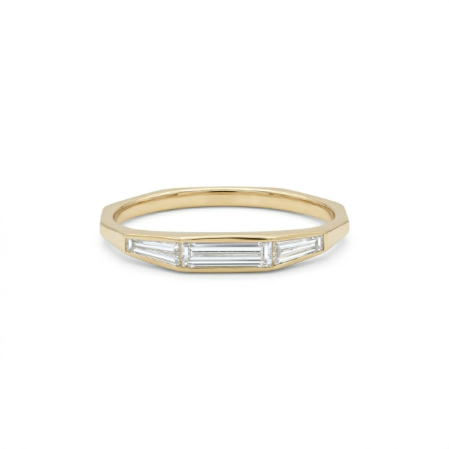 Front view of a 14K gold low profile stackable ring featuring a center straight baguette and side tapered baguette lab diamonds.