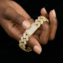 Close-up modeling shot showing a hand holding the 10mm moissanite Cuban bracelet, demonstrating its extreme brilliance and heavy silver weight.