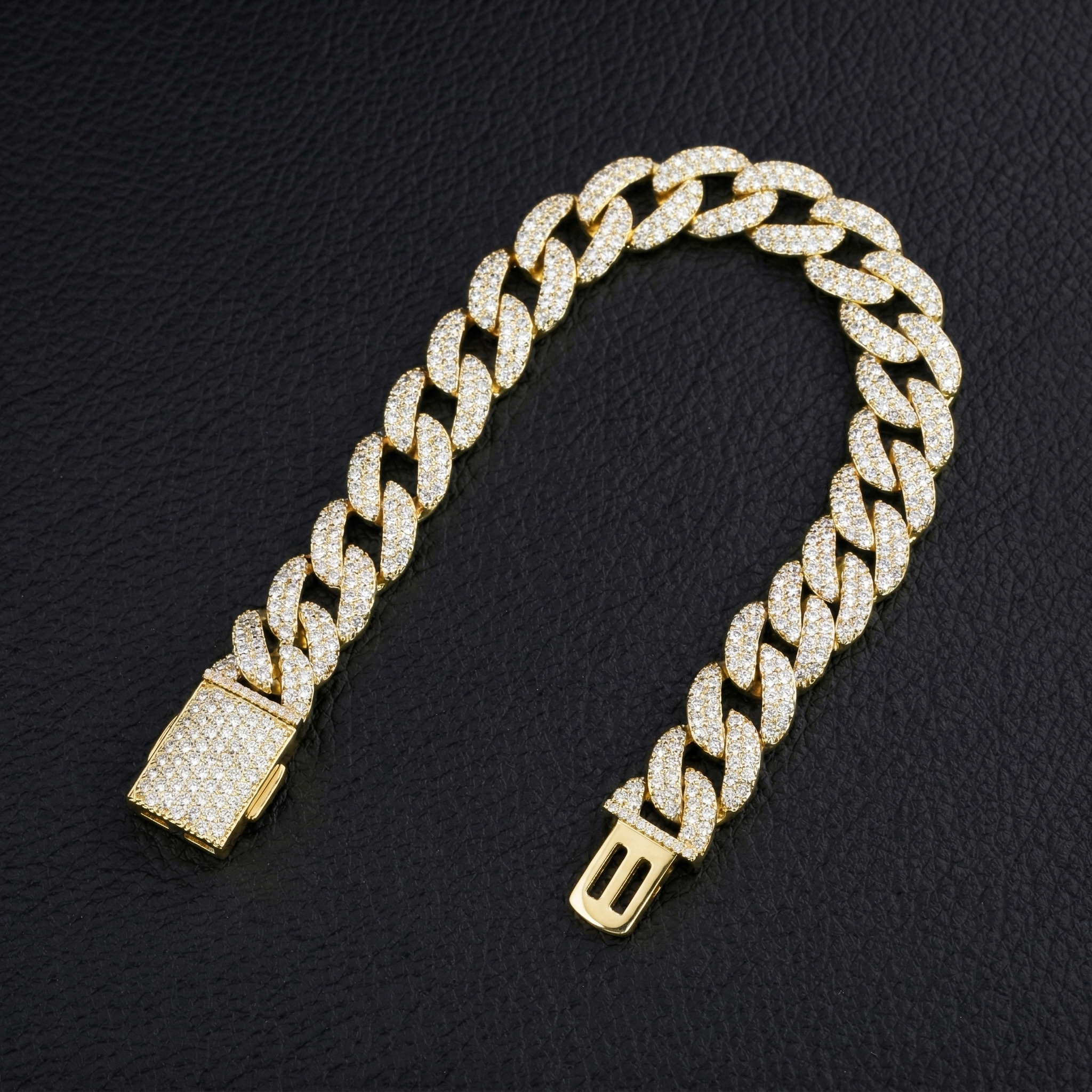 13mm S925 silver moissanite Cuban bracelet folded on a dark leather surface, illustrating the fluid flexibility and anti-roll thin profile engineering.