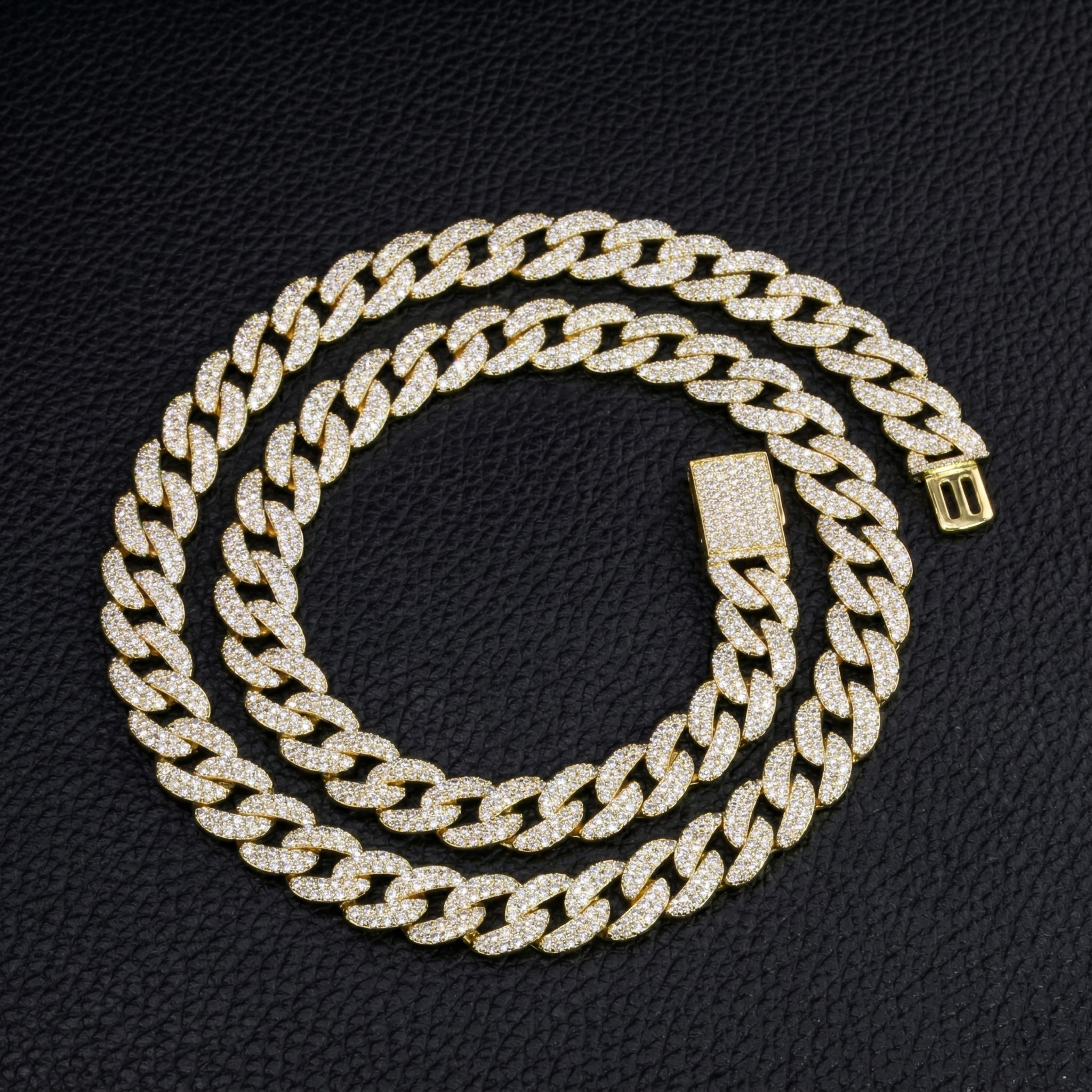 A coiled 13mm fully iced out moissanite Cuban link bracelet showing continuous D-E color flawless sparkle and excellent cut round stones.
