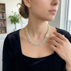 Elegant styling of a VVS moissanite Cuban link chain on a female model, demonstrating the versatility of custom hip-hop jewelry designs.