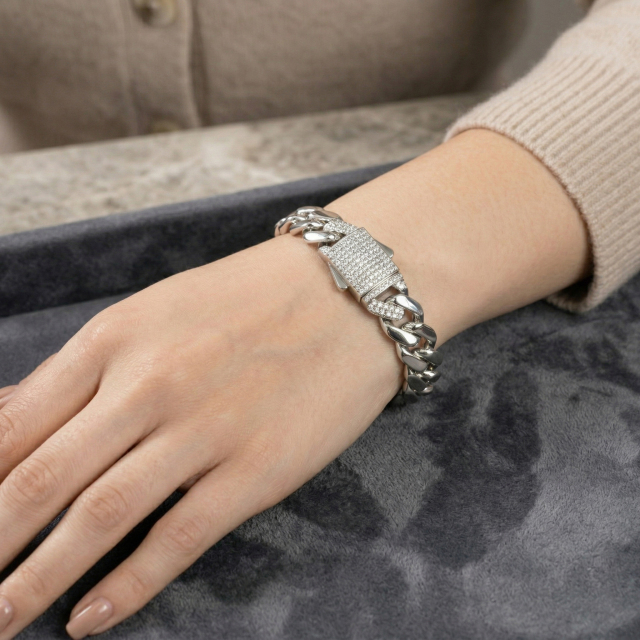Woman's wrist wearing the 10mm moissanite hip hop Cuban bracelet, proving this jewelry is perfect as a unisex luxury gift.