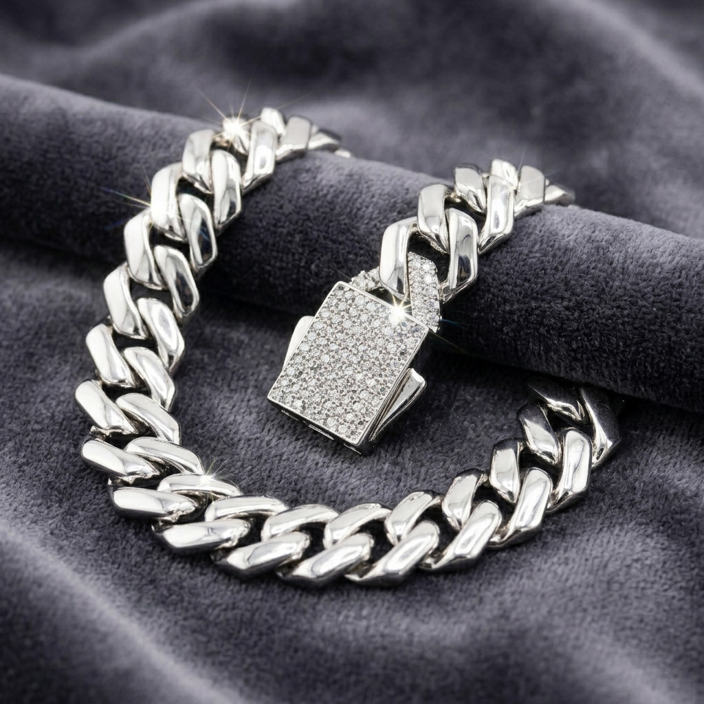 Iced-out Cuban link bracelet resting on grey velvet, highlighting the brilliant moissanite stones and the secure box clasp mechanism.