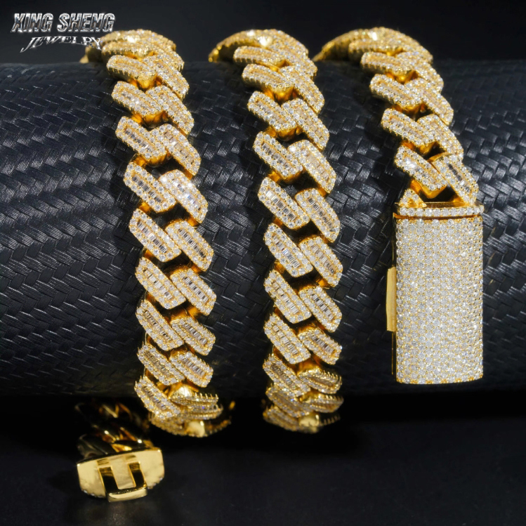 Multiple loops of the 15mm moissanite Cuban chain resting on textured leather, illustrating the flexibility, weight, and premium craftsmanship from our 18-year source jewelry factory.