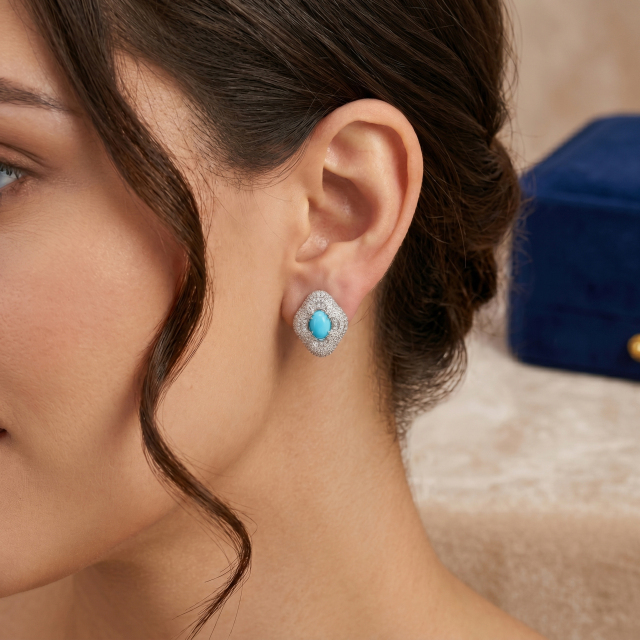 Elegant brunette model wearing the vintage-inspired four-leaf clover moissanite and turquoise stud earrings, showing accurate sizing.