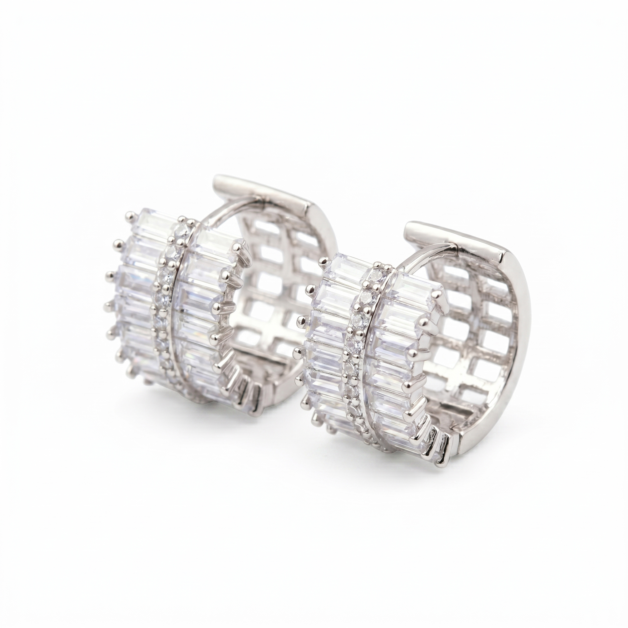 Pair of S925 sterling silver huggie hoop earrings featuring alternating baguette and round cut moissanite stones on a clean white background.