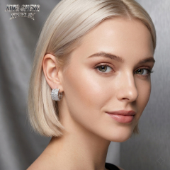 Close-up portrait of a model wearing high-end baguette moissanite earrings by Xing Sheng Jewelry, showcasing timeless everyday luxury.