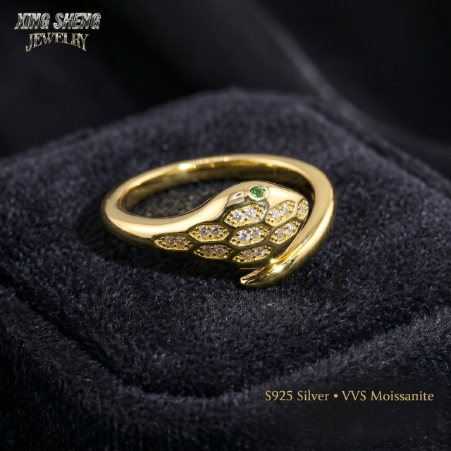 Close-up macro photography of a flawless VVS clarity moissanite snake ring resting in a premium black velvet jewelry box, emphasizing the 6A quality gemstone and thick rhodium finish.