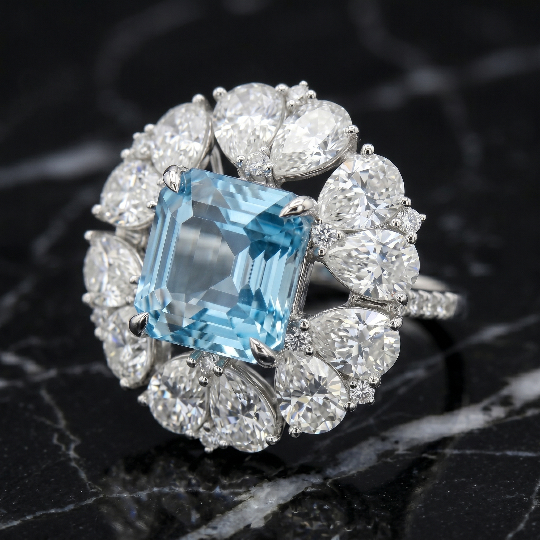 Dramatic close-up of the Asscher cut natural topaz and pear moissanite floral halo ring resting on a luxurious black marble surface, emphasizing gemstone brilliance and fire.